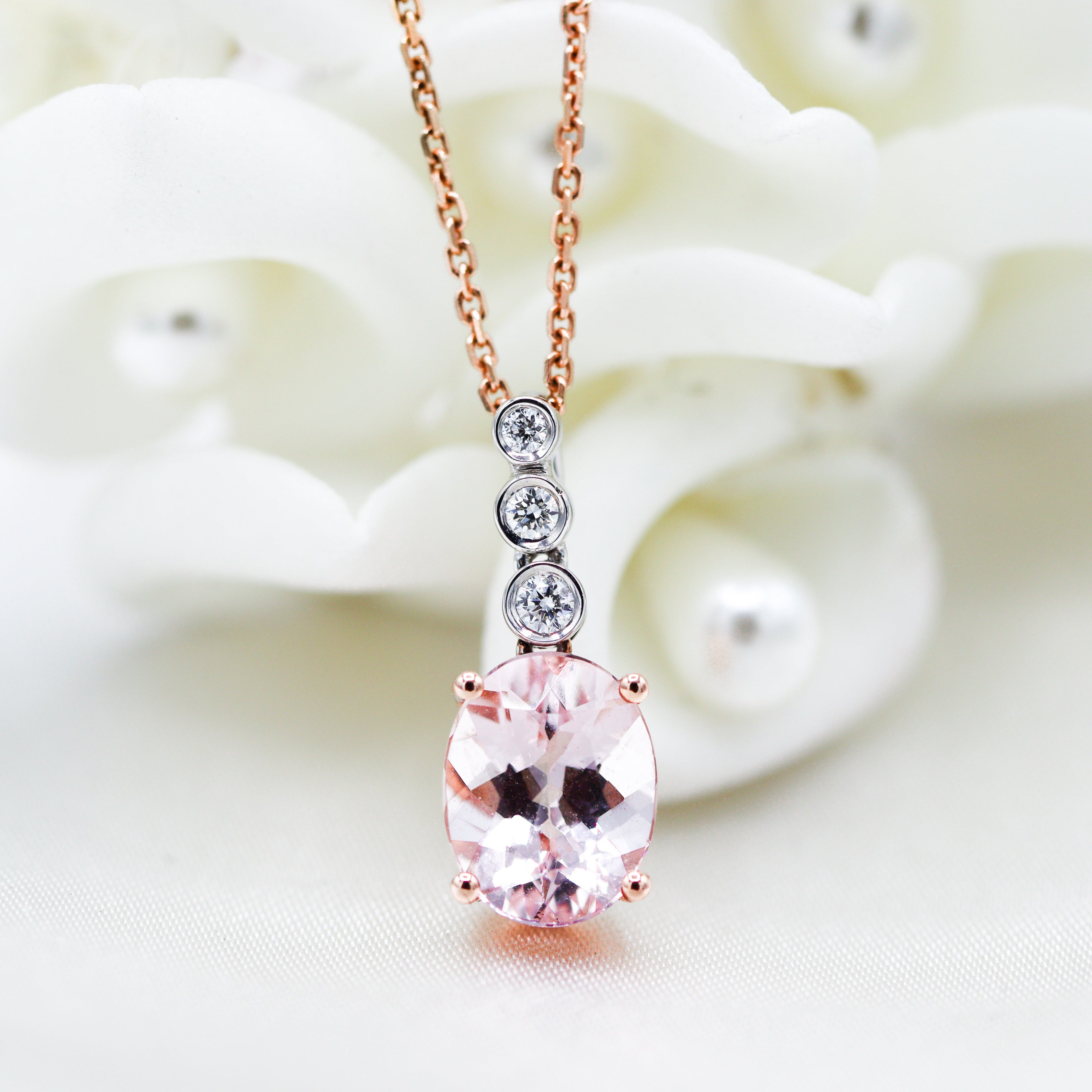 Rose Gold Morganite & Diamond Necklace laying on flowers