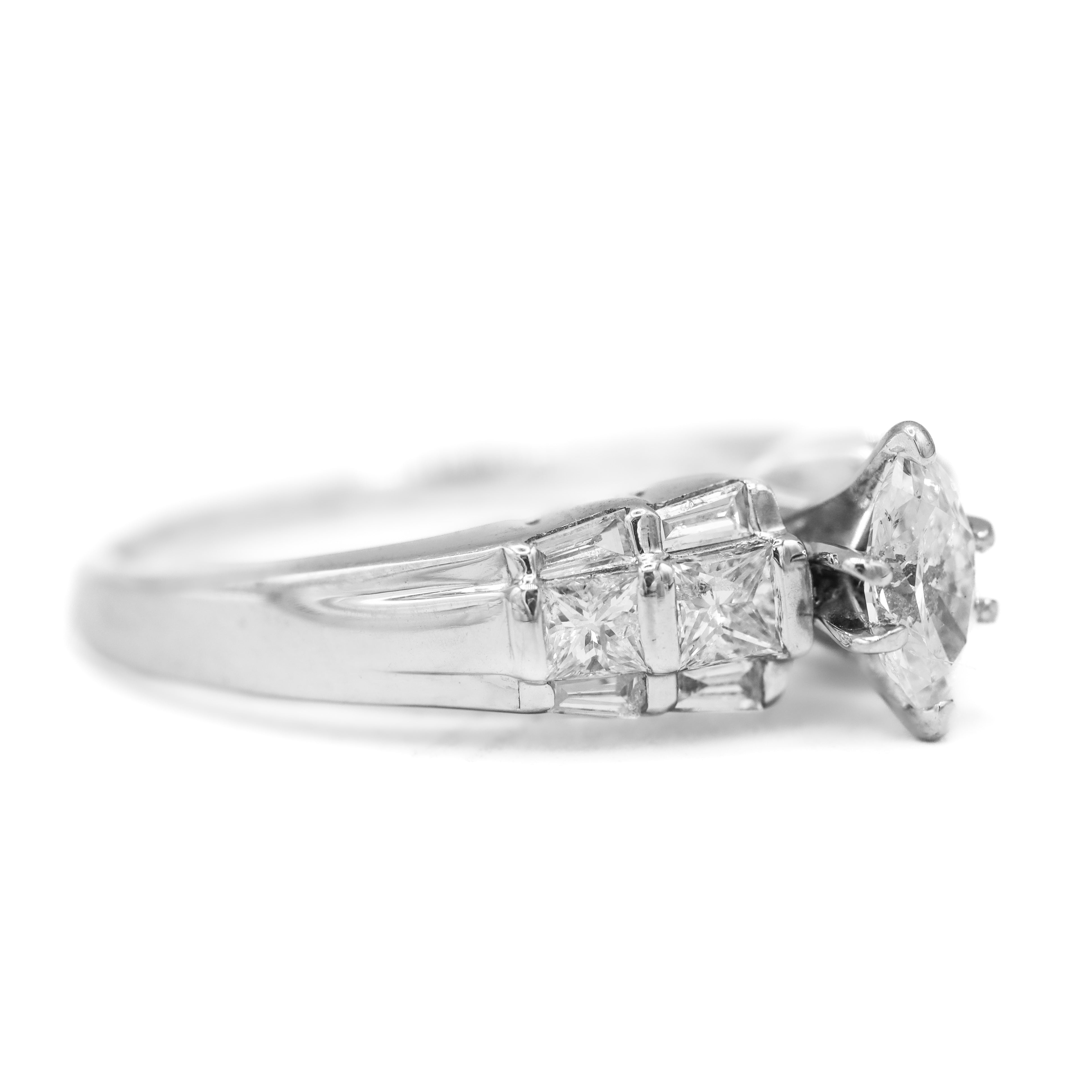 Side view estate marquise diamond center engagement ring with princess cut and baguette accents