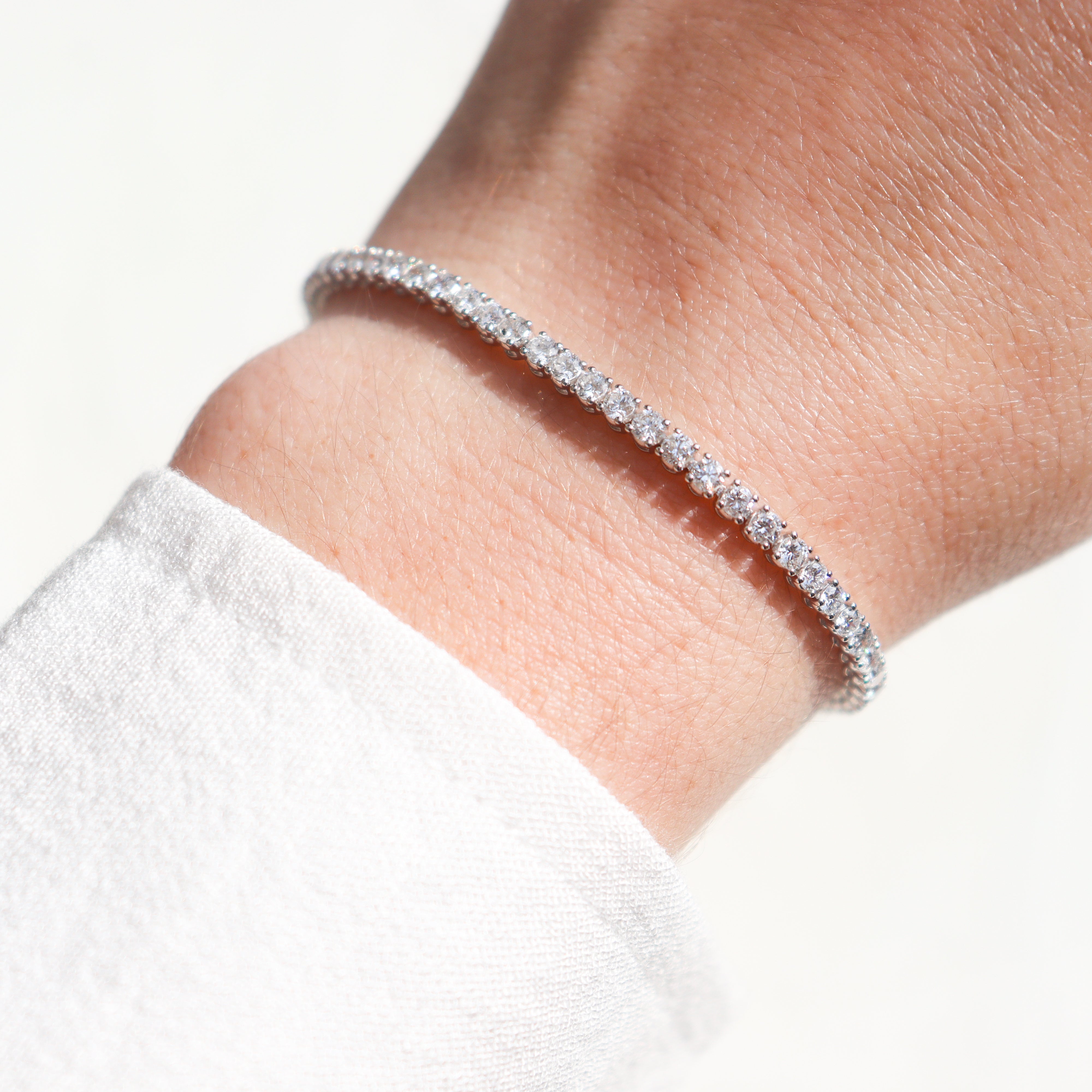 14K White Gold 4CTW. Lab-Grown Diamond Tennis Bracelet on a model's wrist.