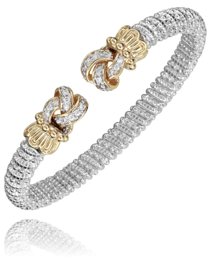 Silver and gold bracelet with floral designs on a white background