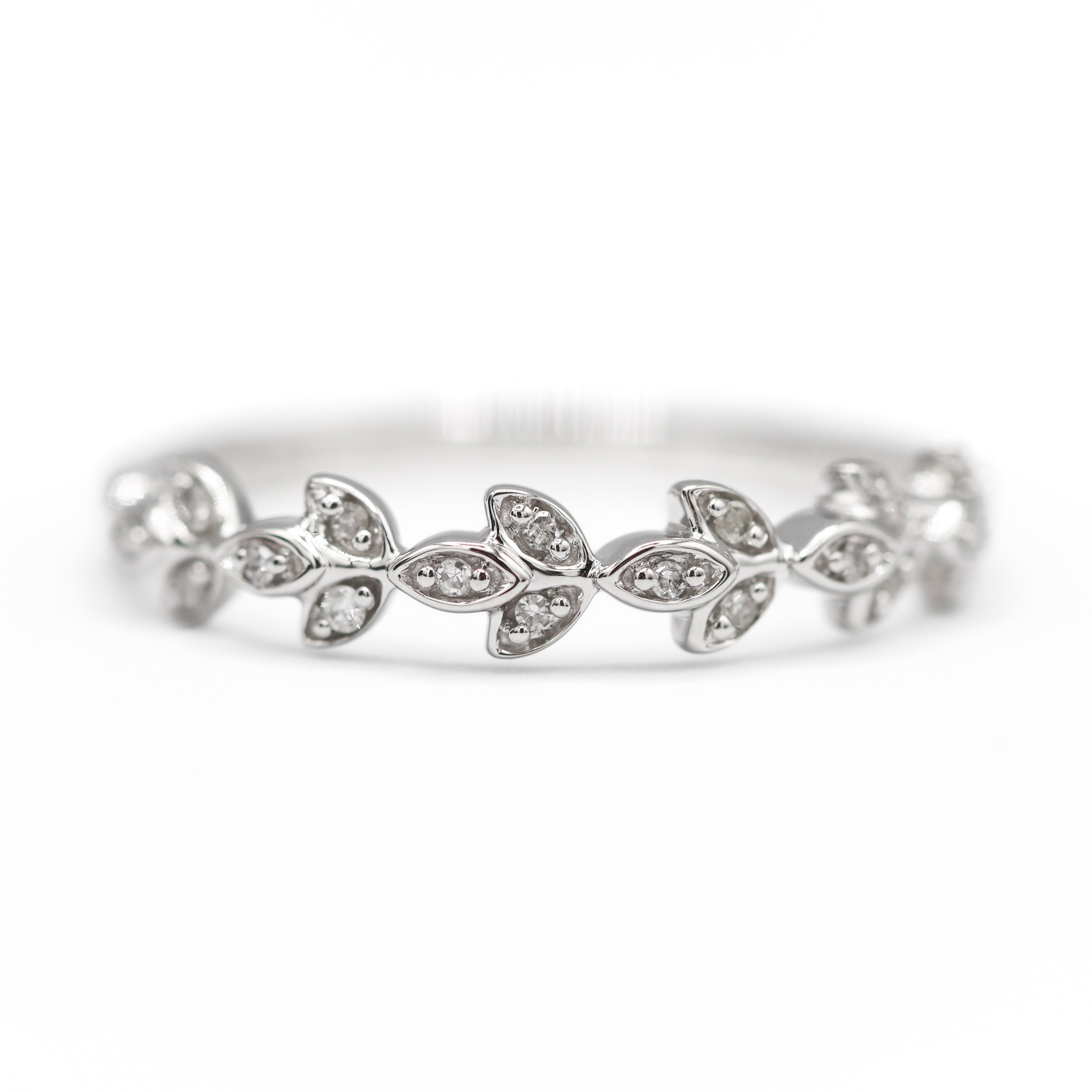 Front view of 10K White Gold 1/20CT. Diamond Leaf Marquise-Style Wedding Band laying flat on a white surface and background.
