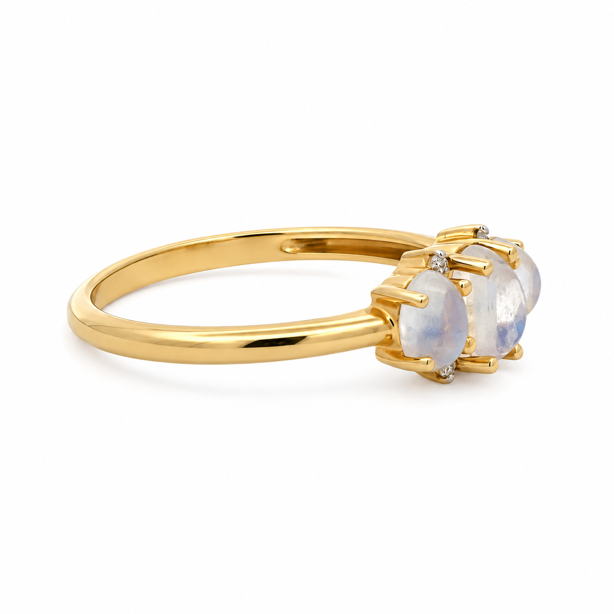 Side view of a three-moonstone and diamond ring showing the raised prong settings and polished yellow gold band.