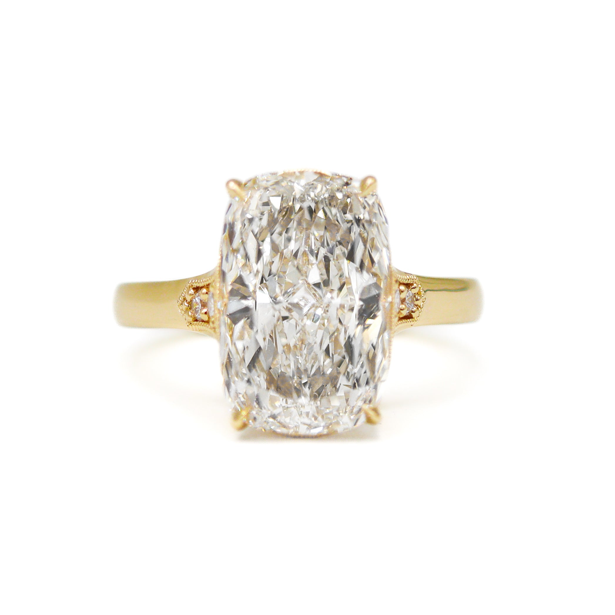 Gold ring with a large diamond on a white background