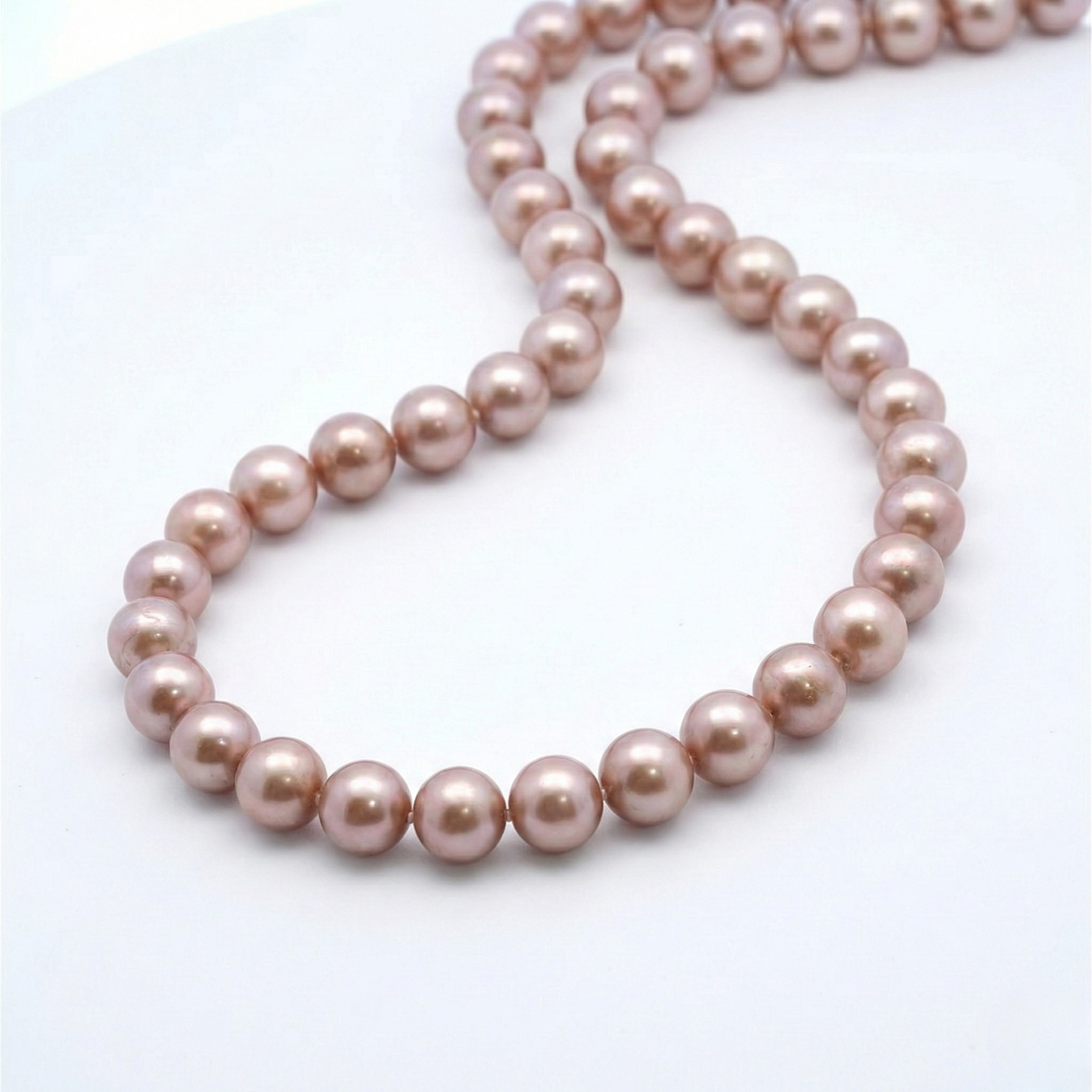 Pink pearl necklace on a white background