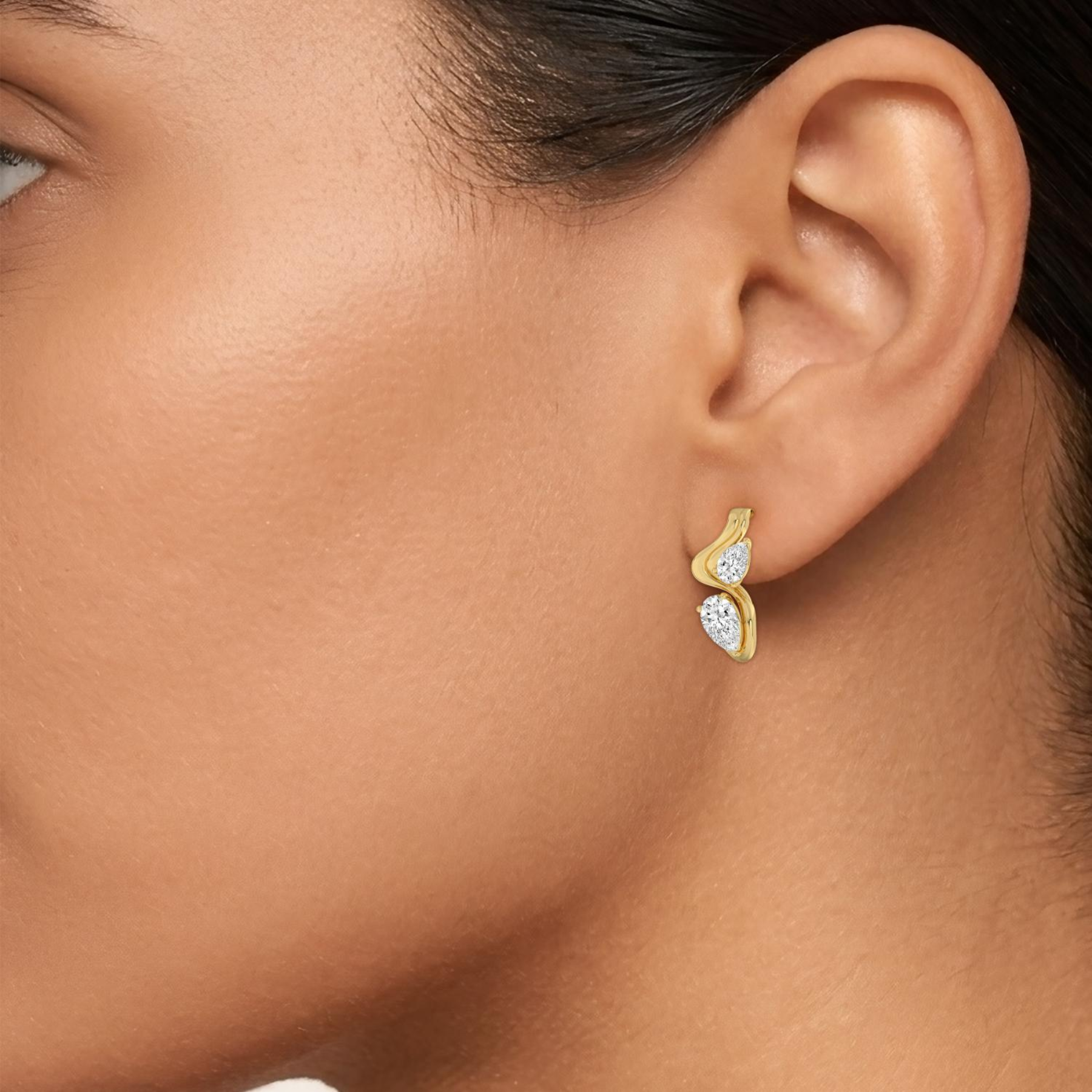 14K Yellow Gold earring modeled on an ear