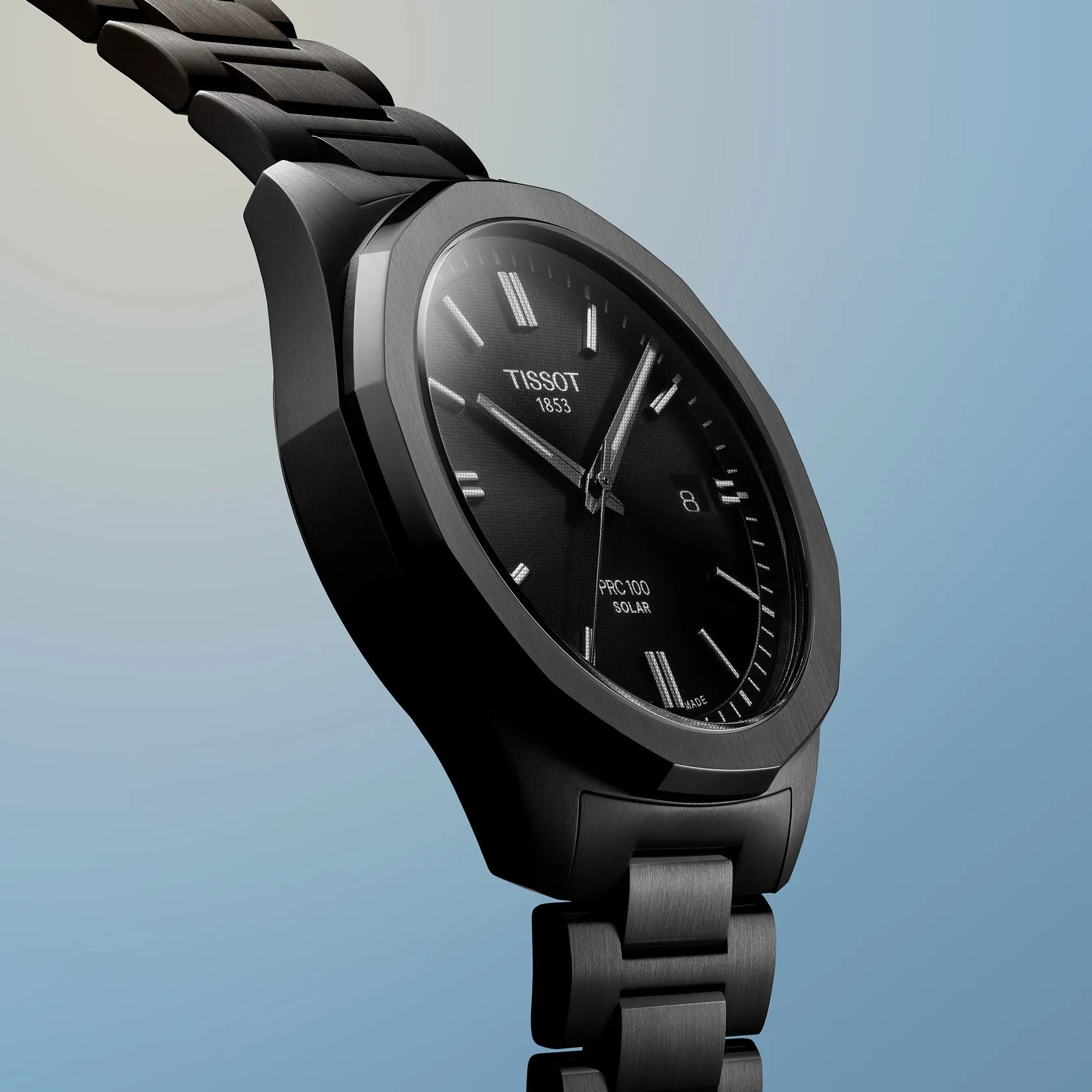 Black Tissot watch on a light blue gradient background