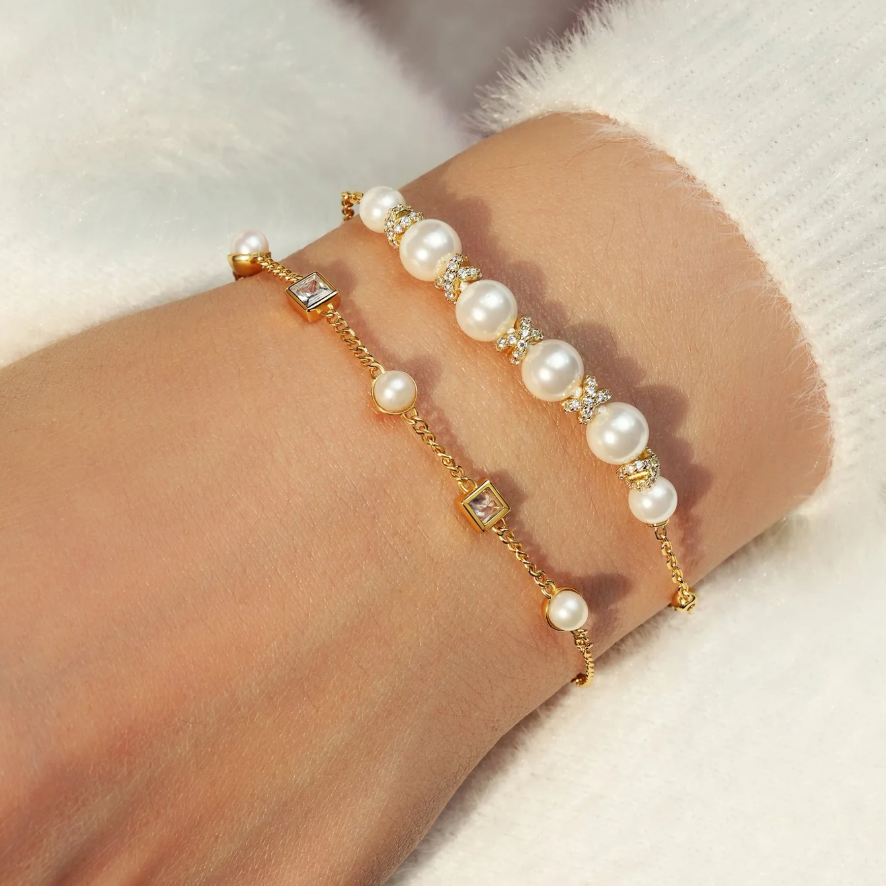 Pearl bracelet with gold accents on a wrist against a soft background
