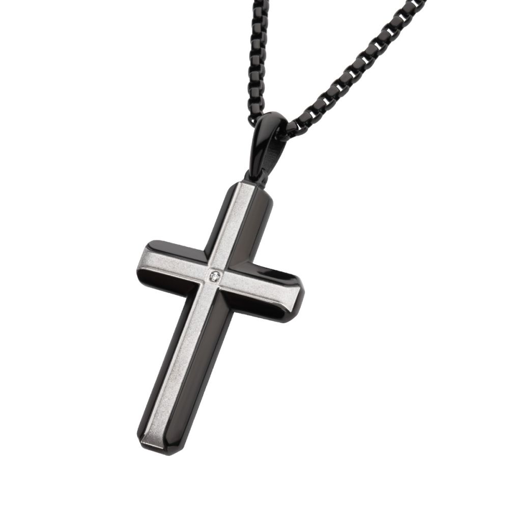 Black and silver cross pendant on a chain against a white background