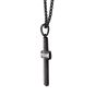 Black pendant necklace on a chain against a neutral background