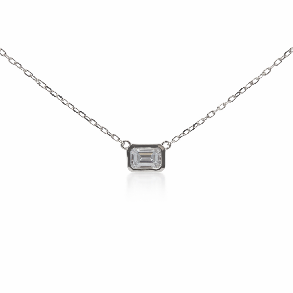 Silver necklace with a rectangular gemstone on a white background