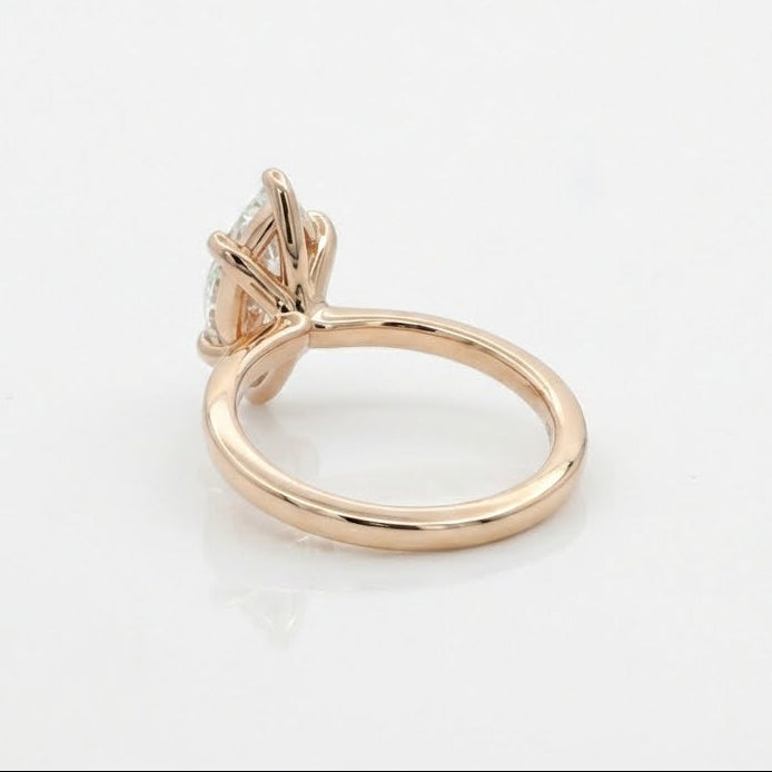 Rose gold ring with a diamond on a white background