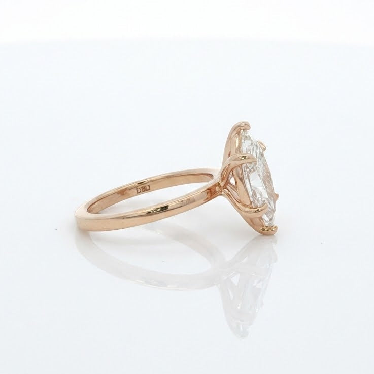Rose gold ring with a diamond on a white background
