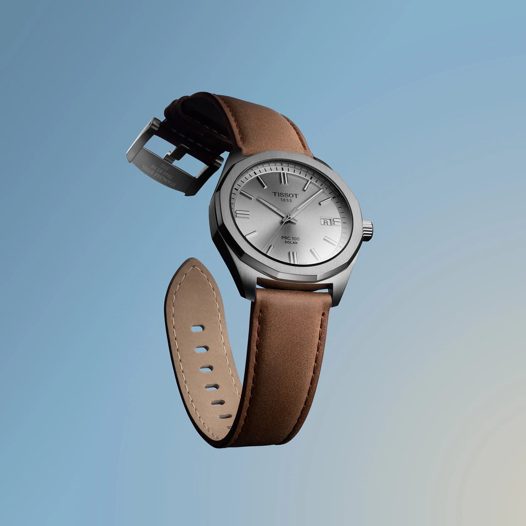 Tissot watch with brown leather strap on a gradient blue background
