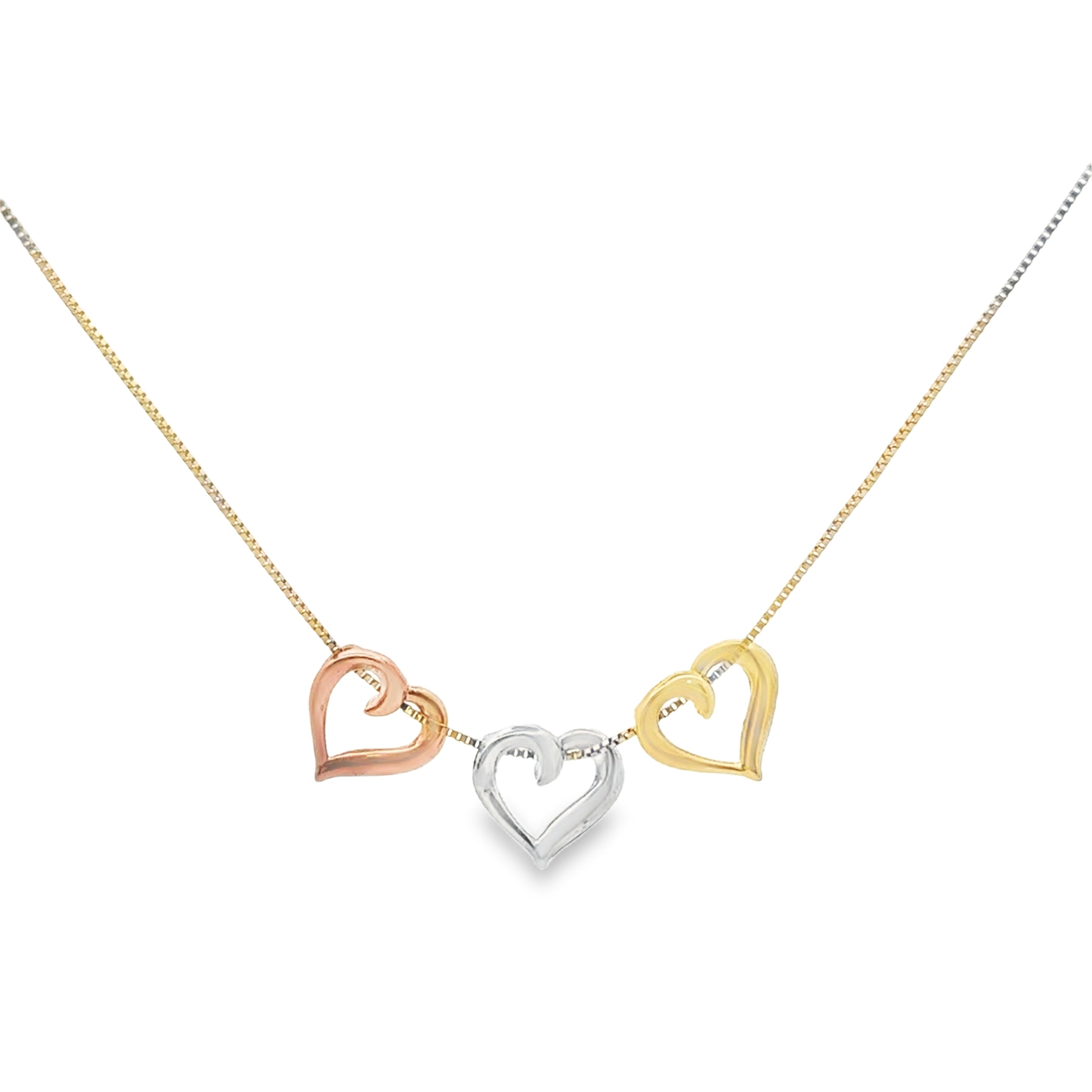 Three heart-shaped pendants on a gold chain against a white background