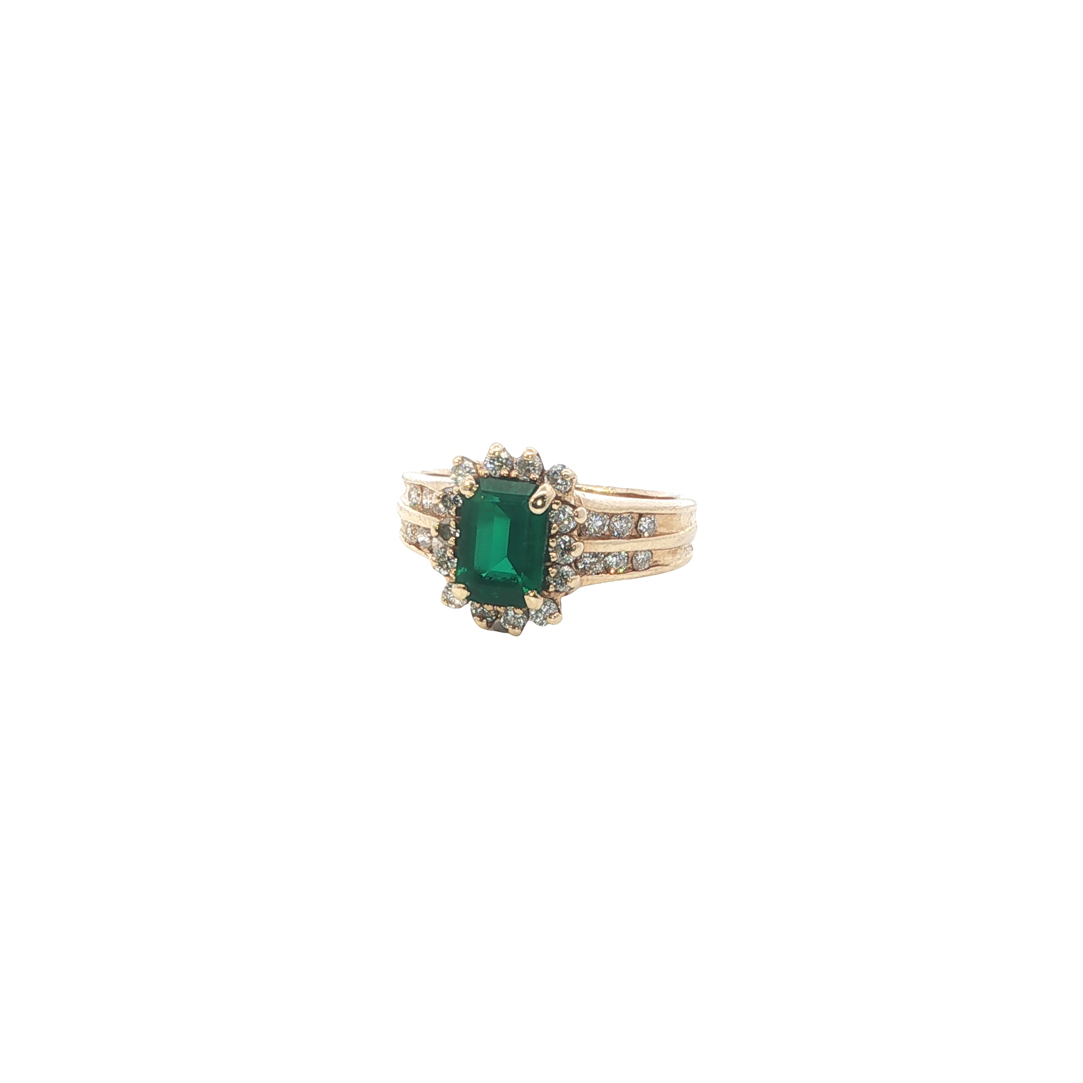 Gold ring with a green gemstone on a white background