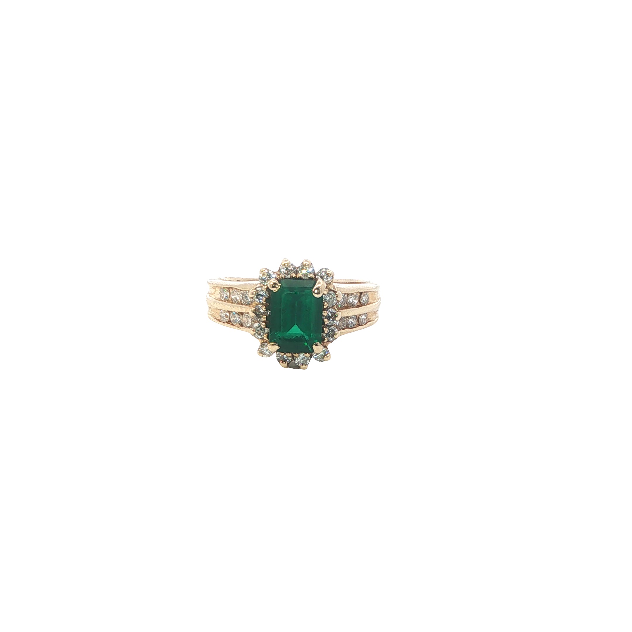 Gold ring with a green gemstone on a white background