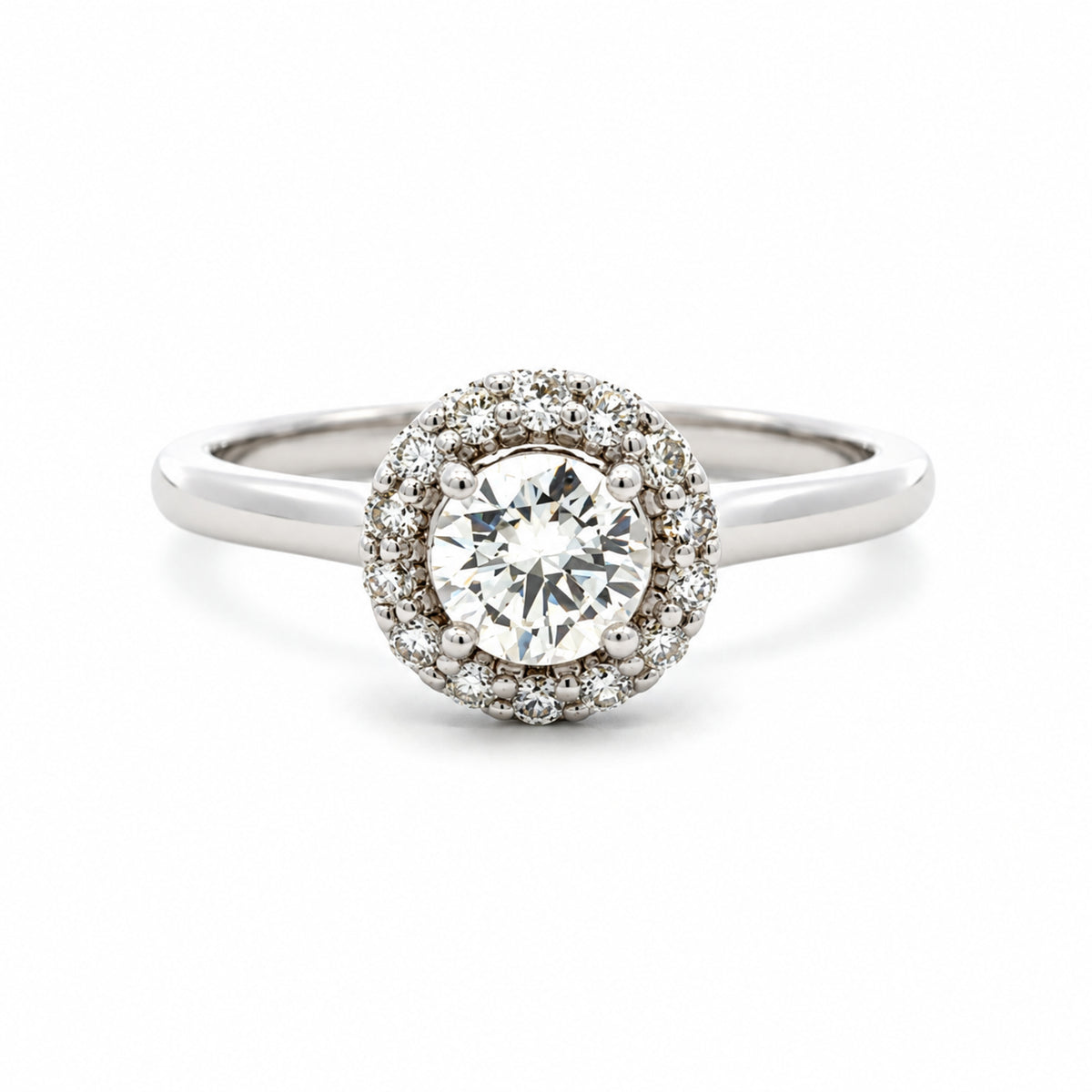 Front view of estate 14K white gold natural diamond halo ring with a polished band, shown on a white background with a soft shadow.