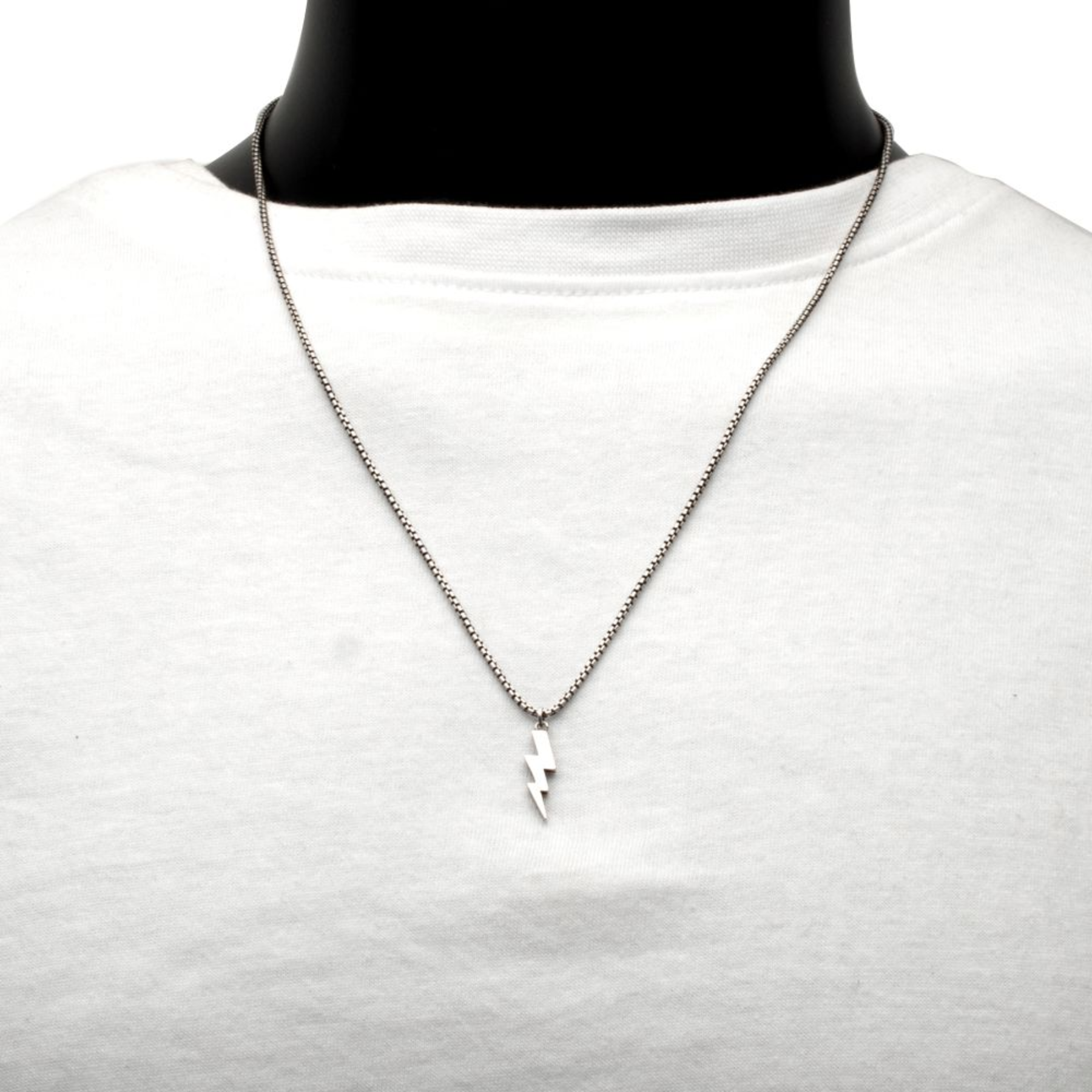 Necklace with a lightning bolt pendant on a mannequin wearing a white shirt.