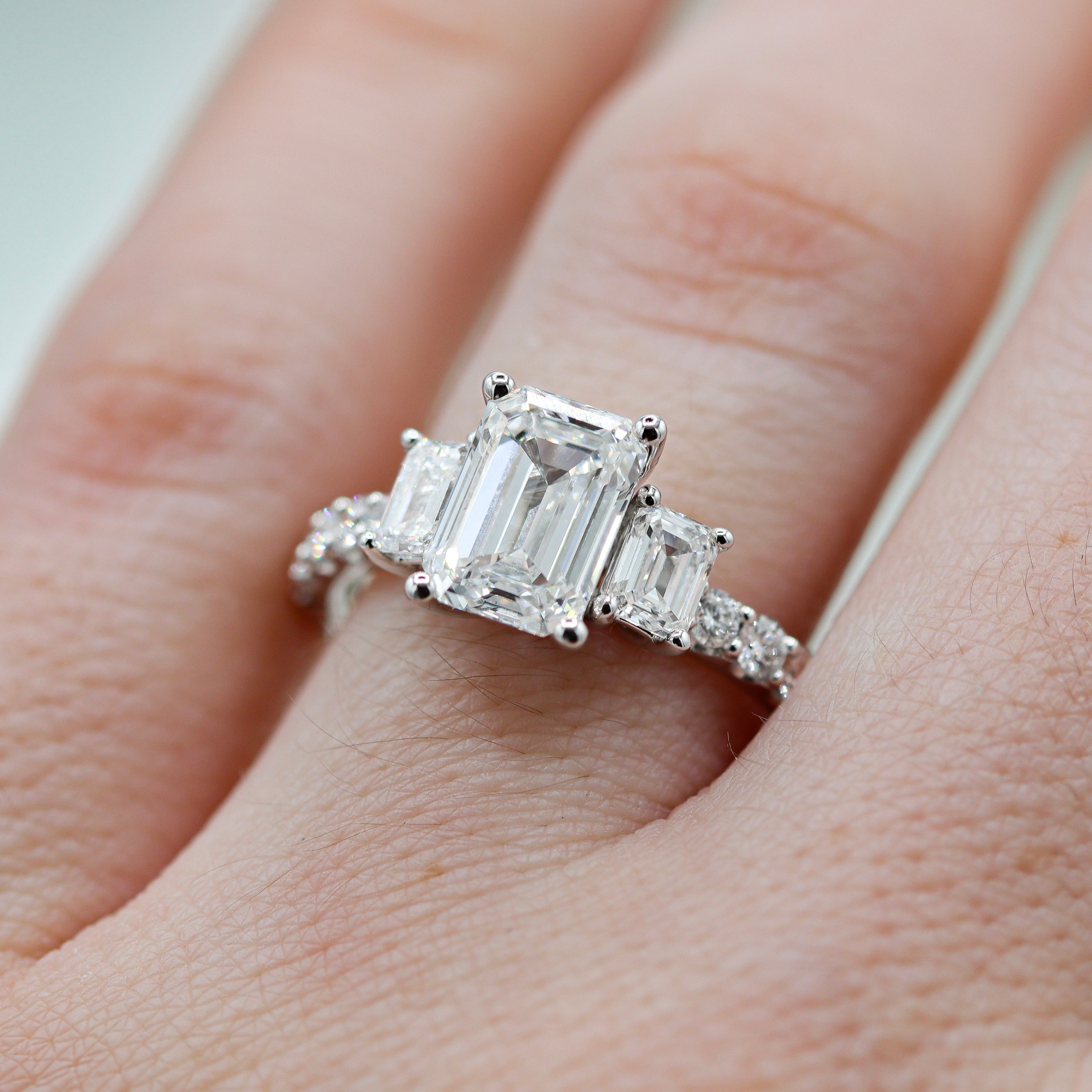 14K White Gold 3CTW. Emerald-Cut Lab-Grown Diamond Accented Engagement Ring on a hand