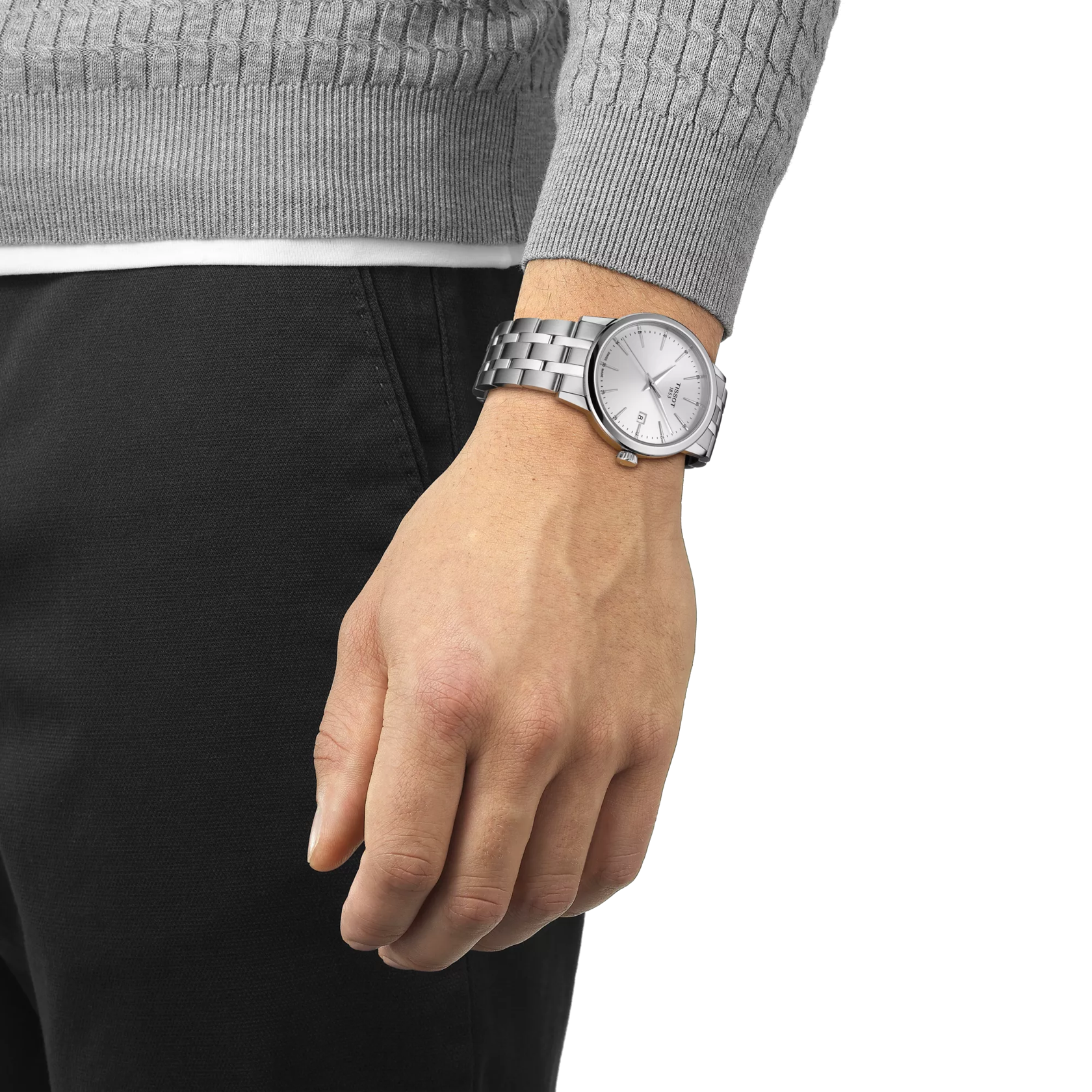Silver watch on a person's wrist with a neutral background