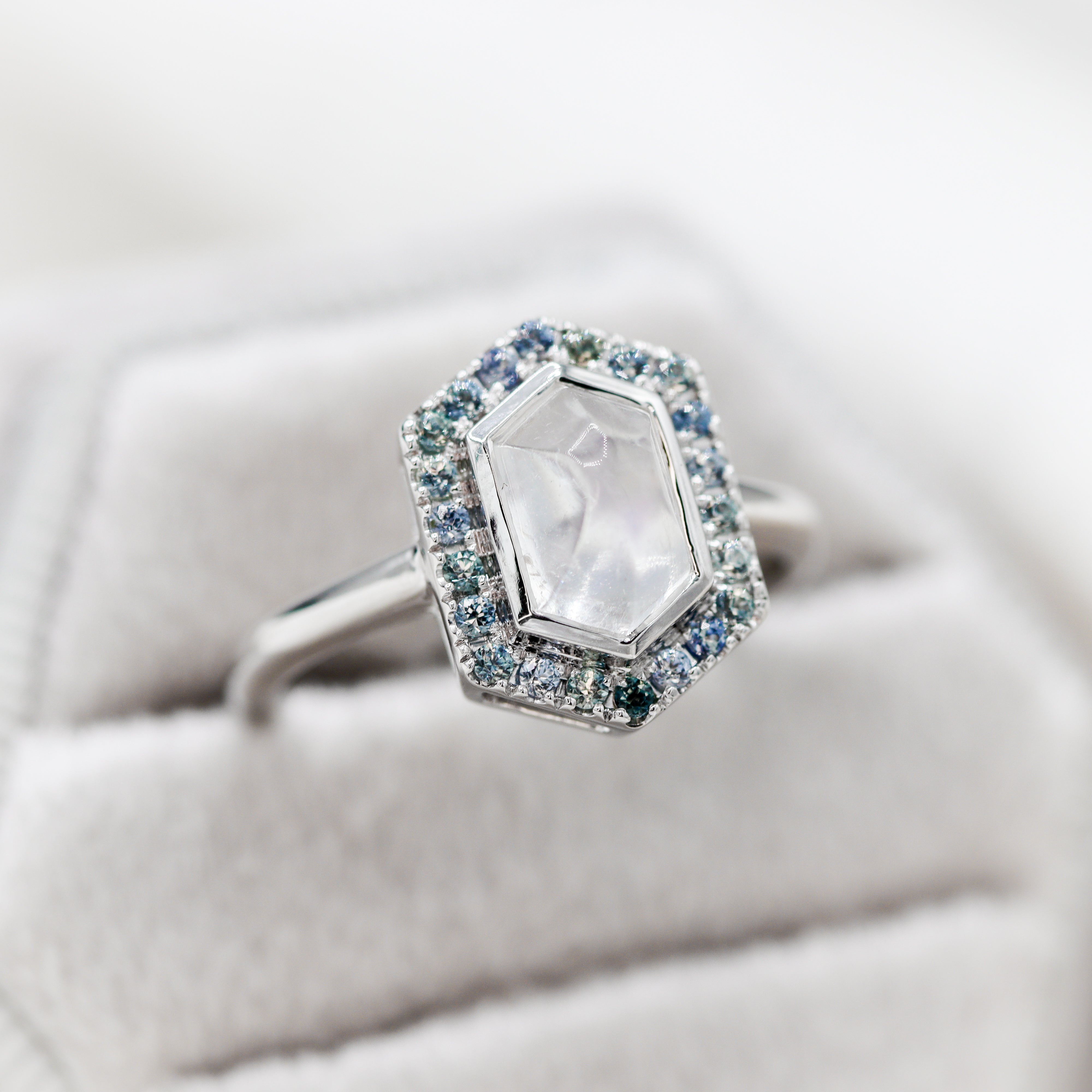 14K White Gold Moonstone Hexagon Teal Sapphire Halo Ring in a velvet ring box