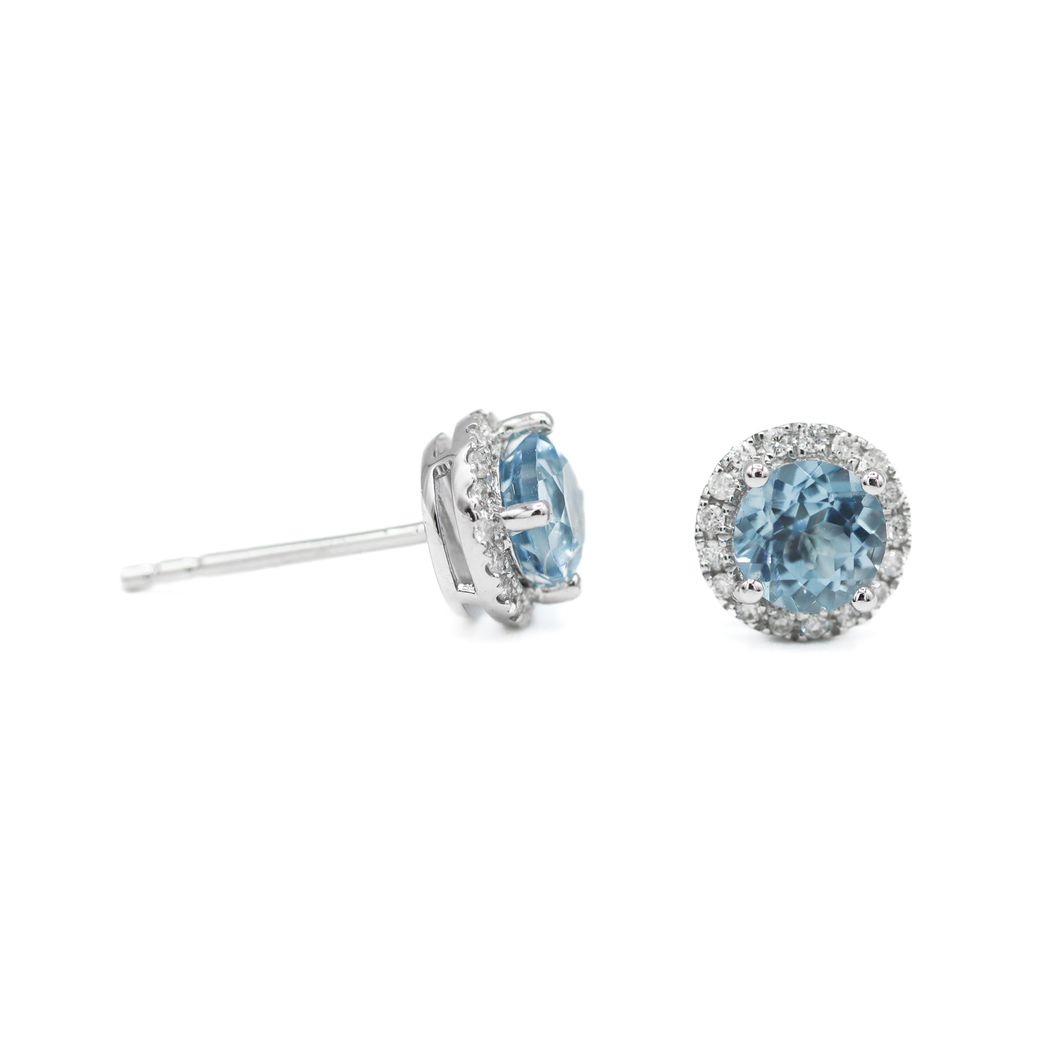 Left turned sideways and right straight-on view of 14K White Gold 1CTW. Sky Blue Topaz & 1/6CT. Diamond Halo Stud Earrings on white background.