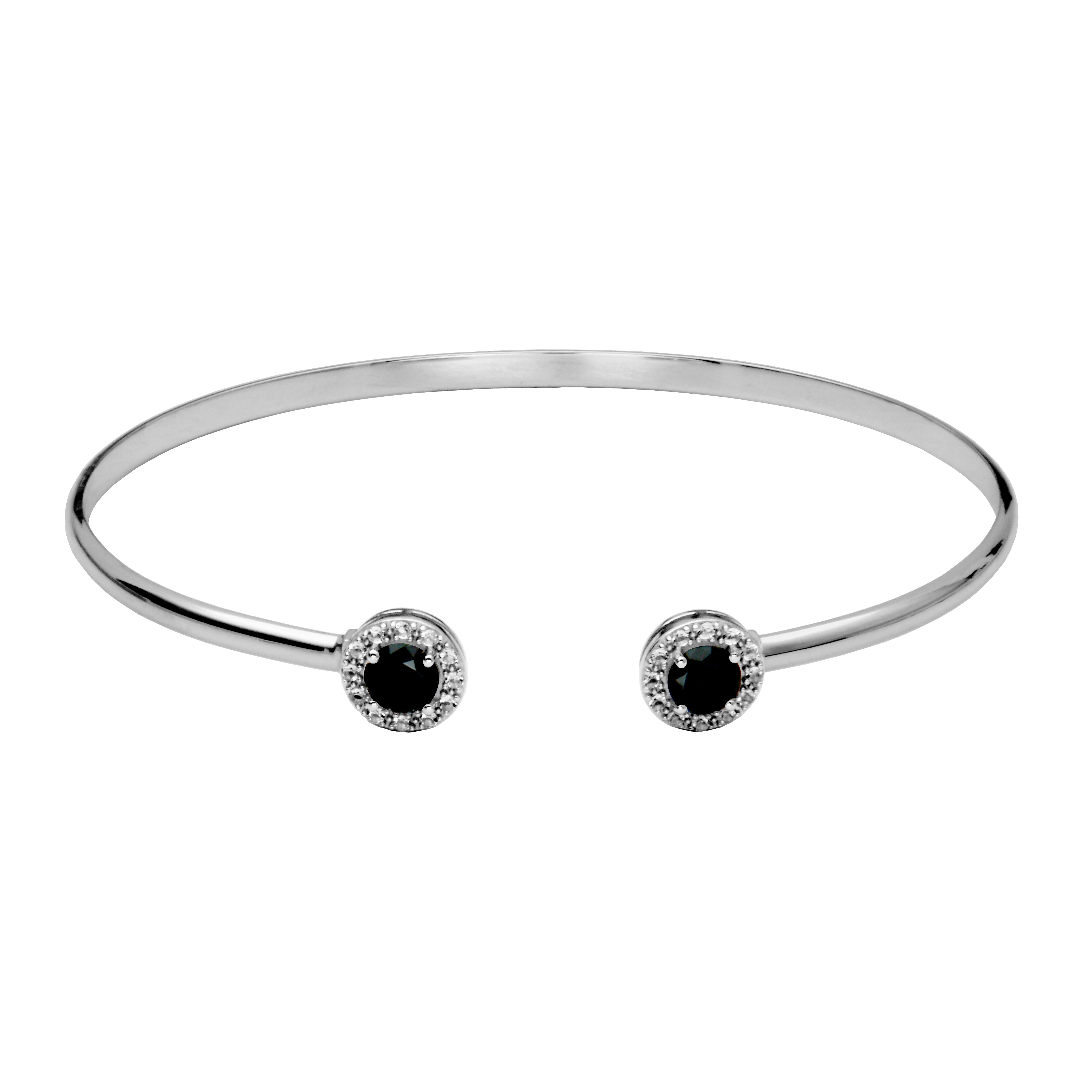 Silver Cuff Bracelet. On each end of the cuff is a round black spinel surrounded by a halo of white topaz gemstones.f