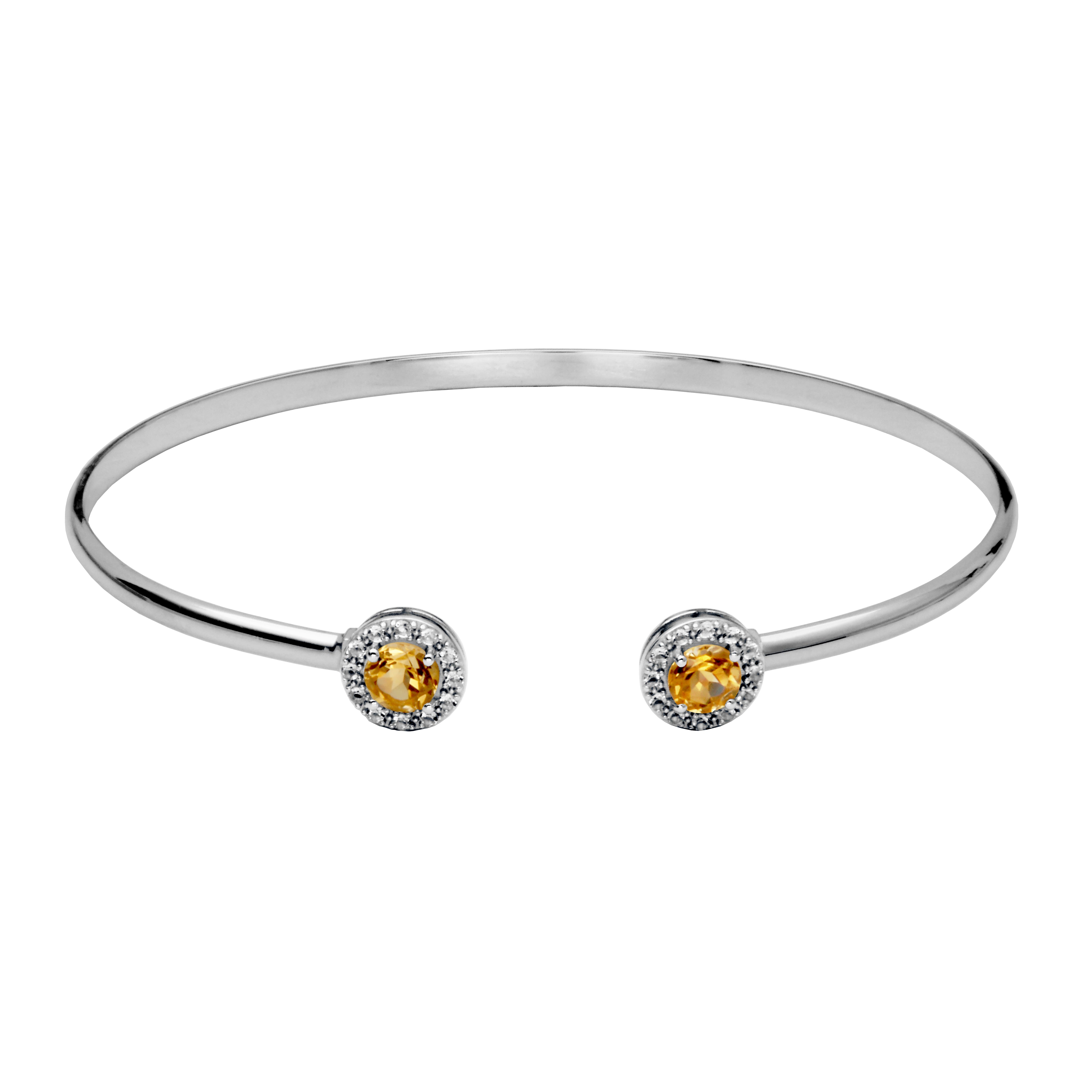 Silver cuff bangle bracelet. On each end of the cuff is a round citrine surrounded by a halo of white topaz gemstones.