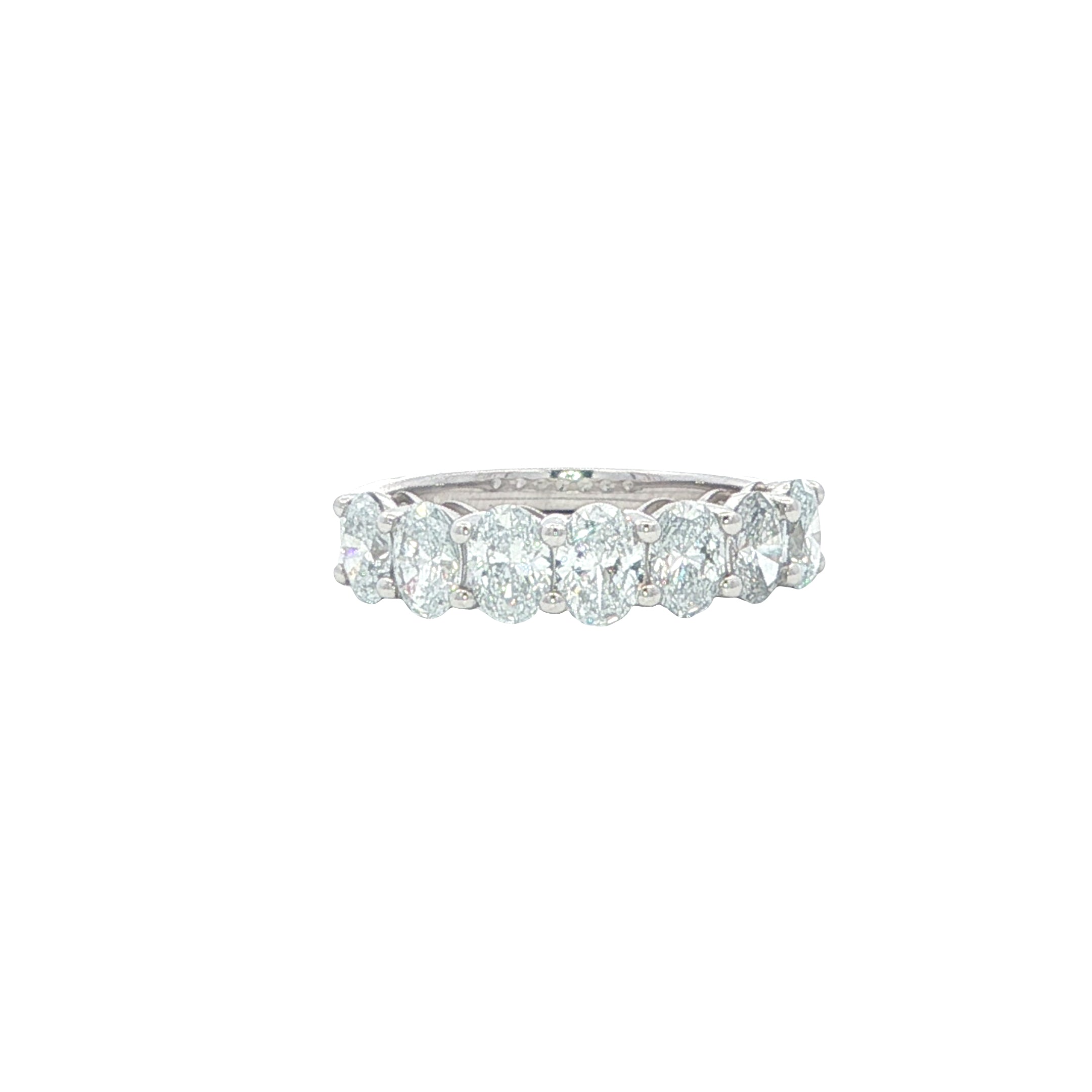 Diamond ring with multiple stones on a white background