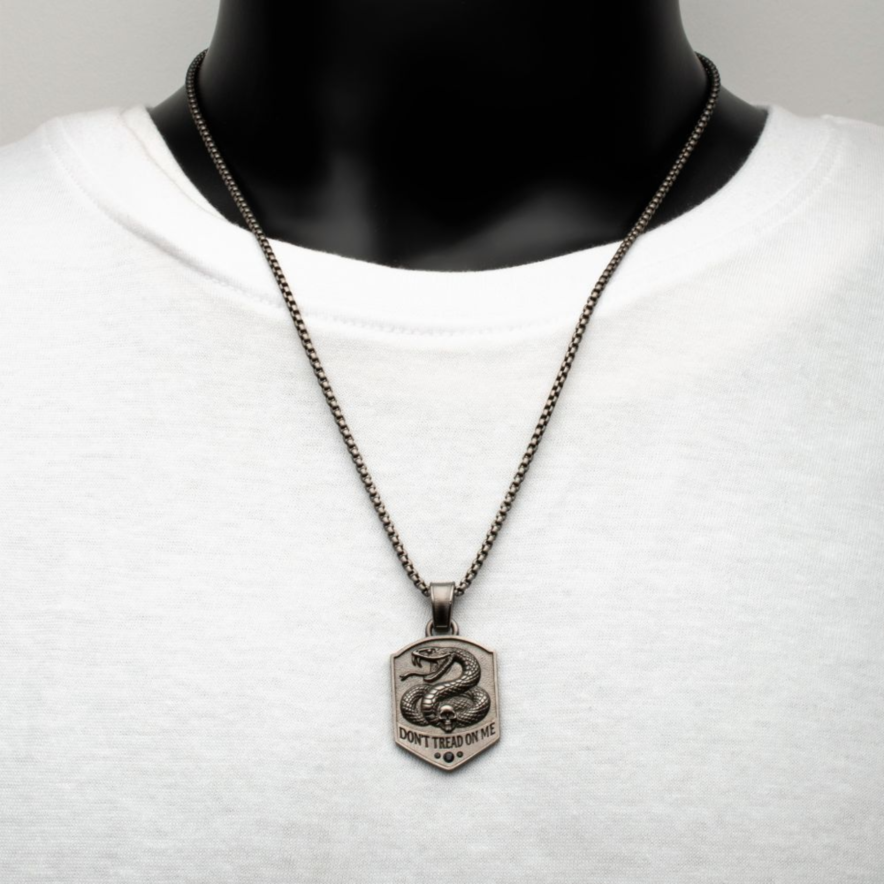 Necklace with a snake pendant on a mannequin against a white background
