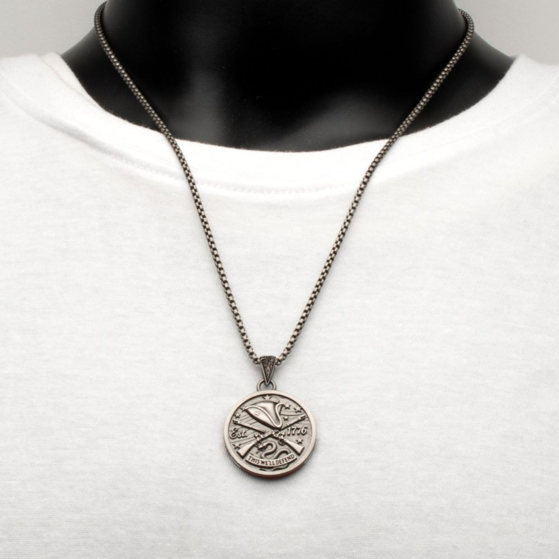 Necklace with a circular pendant on a mannequin against a white background