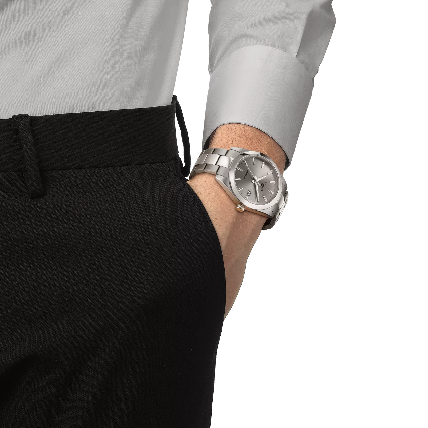 Silver watch on a person's wrist with a white shirt and black pants.