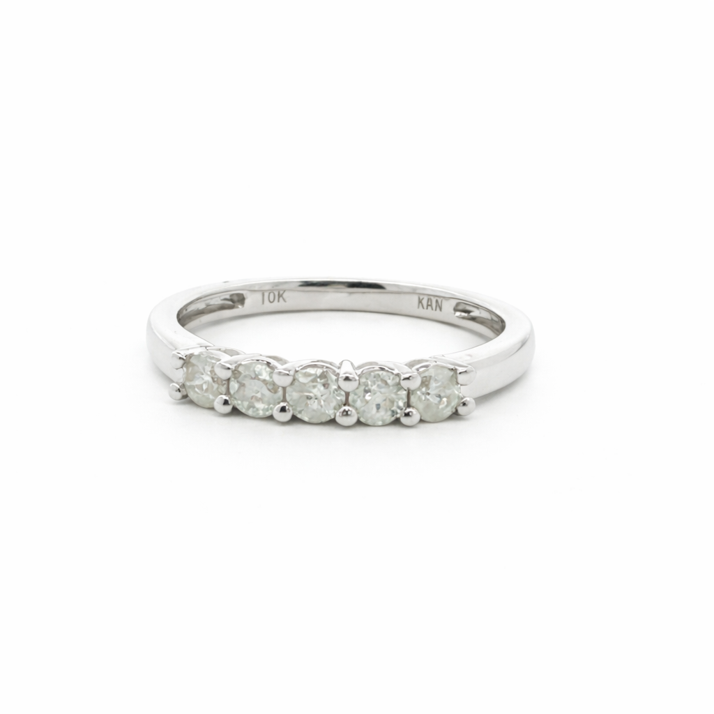 Silver ring with five diamonds on a white background