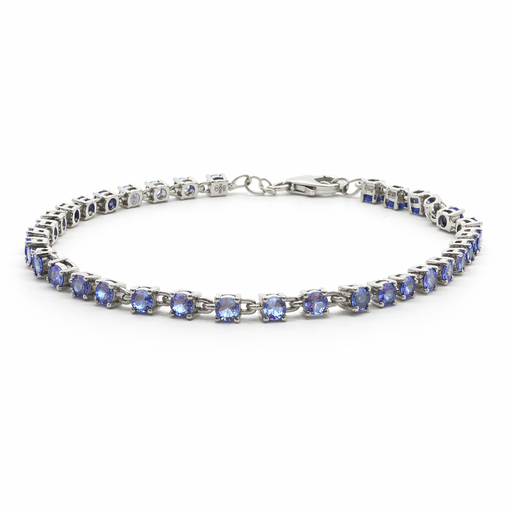 Silver bracelet with blue gemstones on a white background