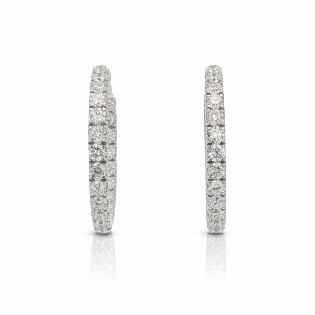 Pair of silver hoop earrings on a white background