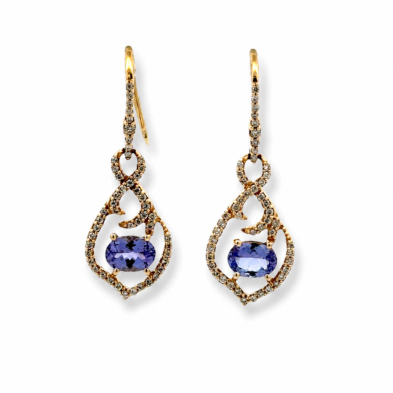 A pair of gold drop earrings featuring oval blue tanzanite gemstones surrounded by small pavé-set clear stones, shown on a plain white background.