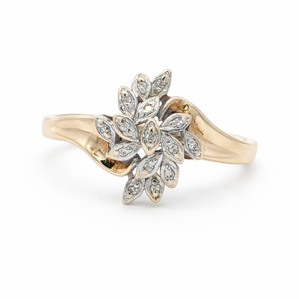 Gold ring with diamond leaf design on a white background