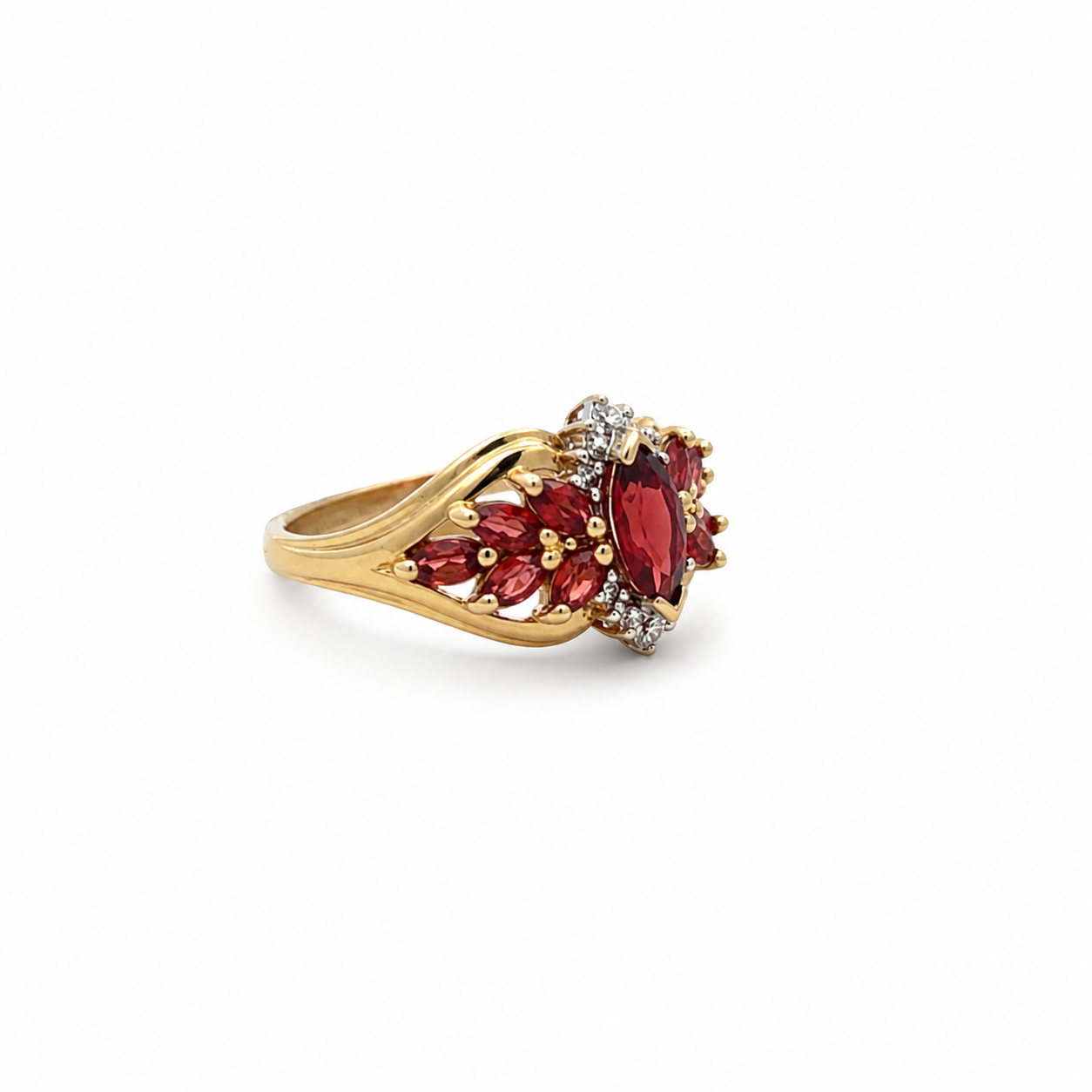 Gold ring with red gemstones on a white background