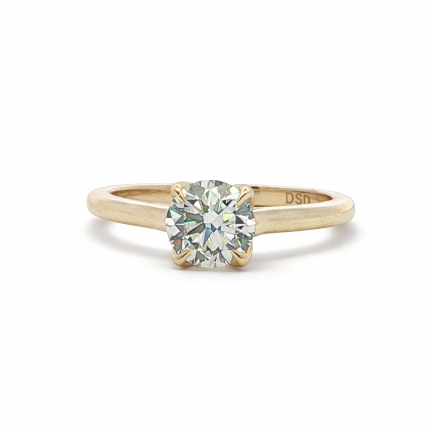 Gold ring with a diamond on a white background