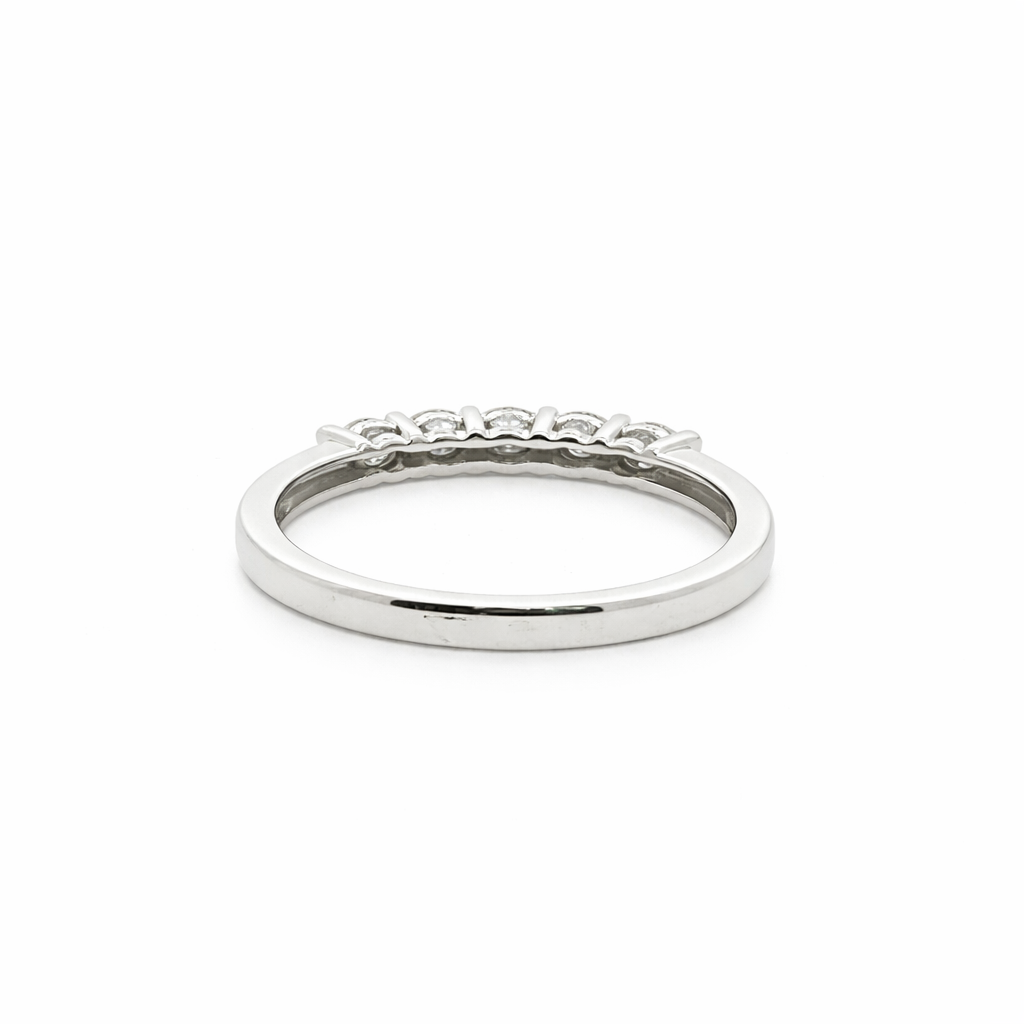 Silver ring with small diamonds on a white background