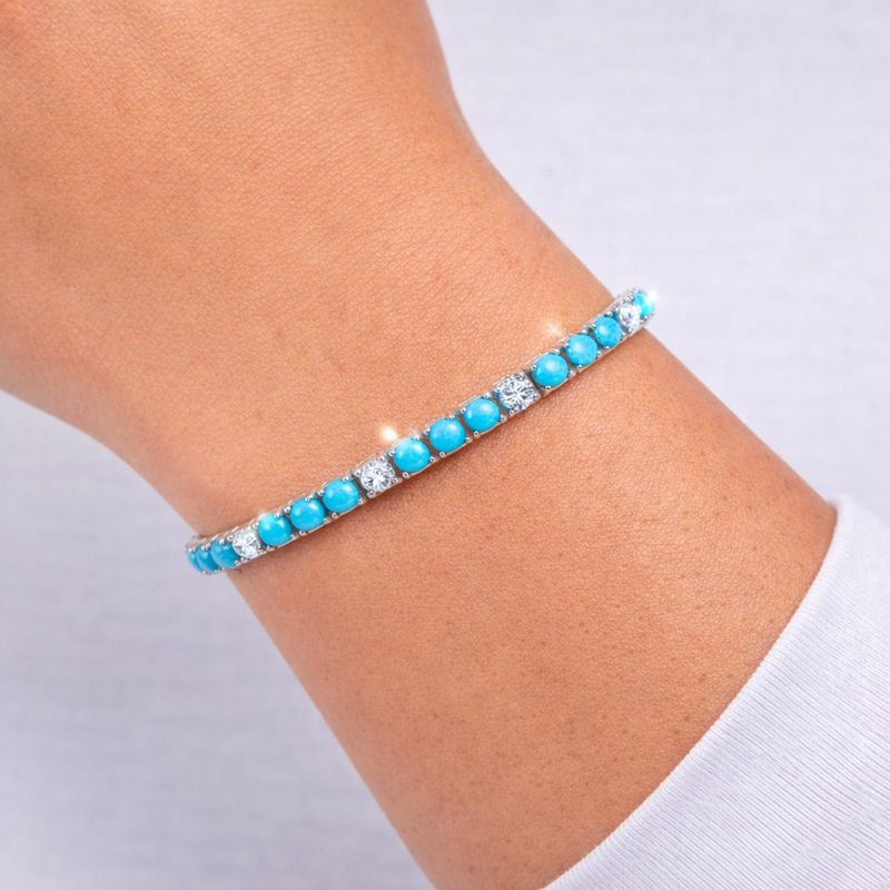 White and turquoise bracelet on white background