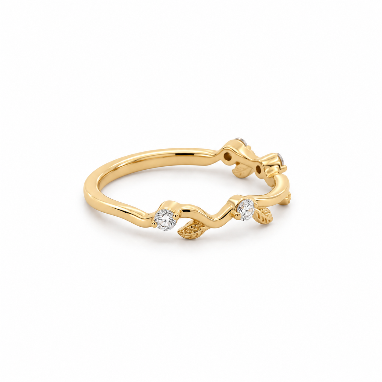 A delicate yellow gold ring featuring a wavy vine design with small textured leaf details and two clear round-cut gemstones, shown on a plain white background.
