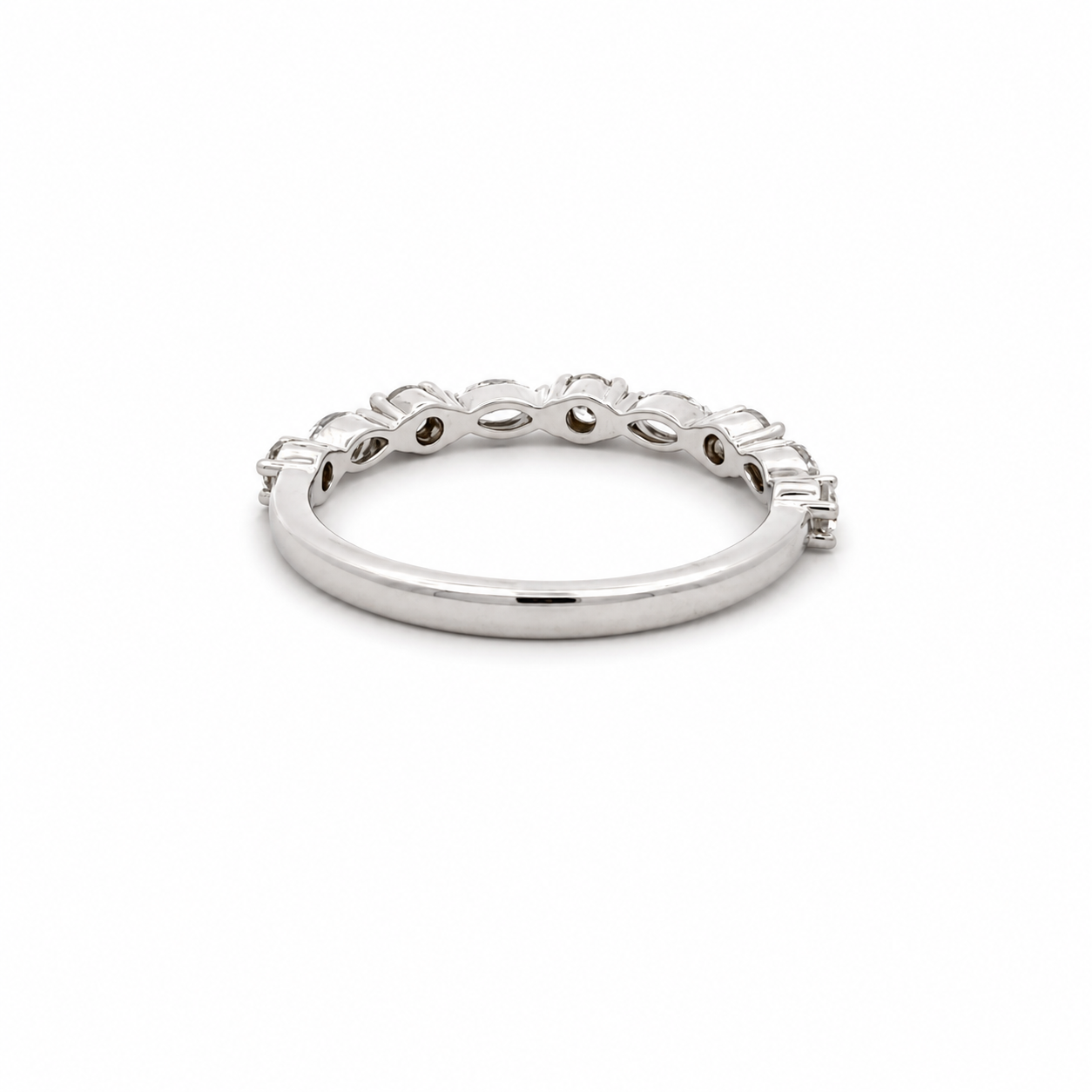A silver-toned eternity band ring featuring a continuous row of small round-cut clear stones set in a polished band, shown on a plain white background.