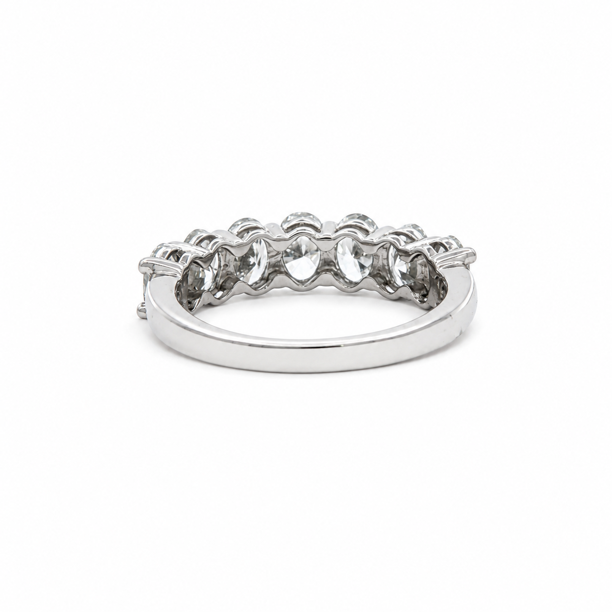 A silver-toned eternity ring featuring a row of clear round-cut gemstones set in a polished band, shown against a plain white background.