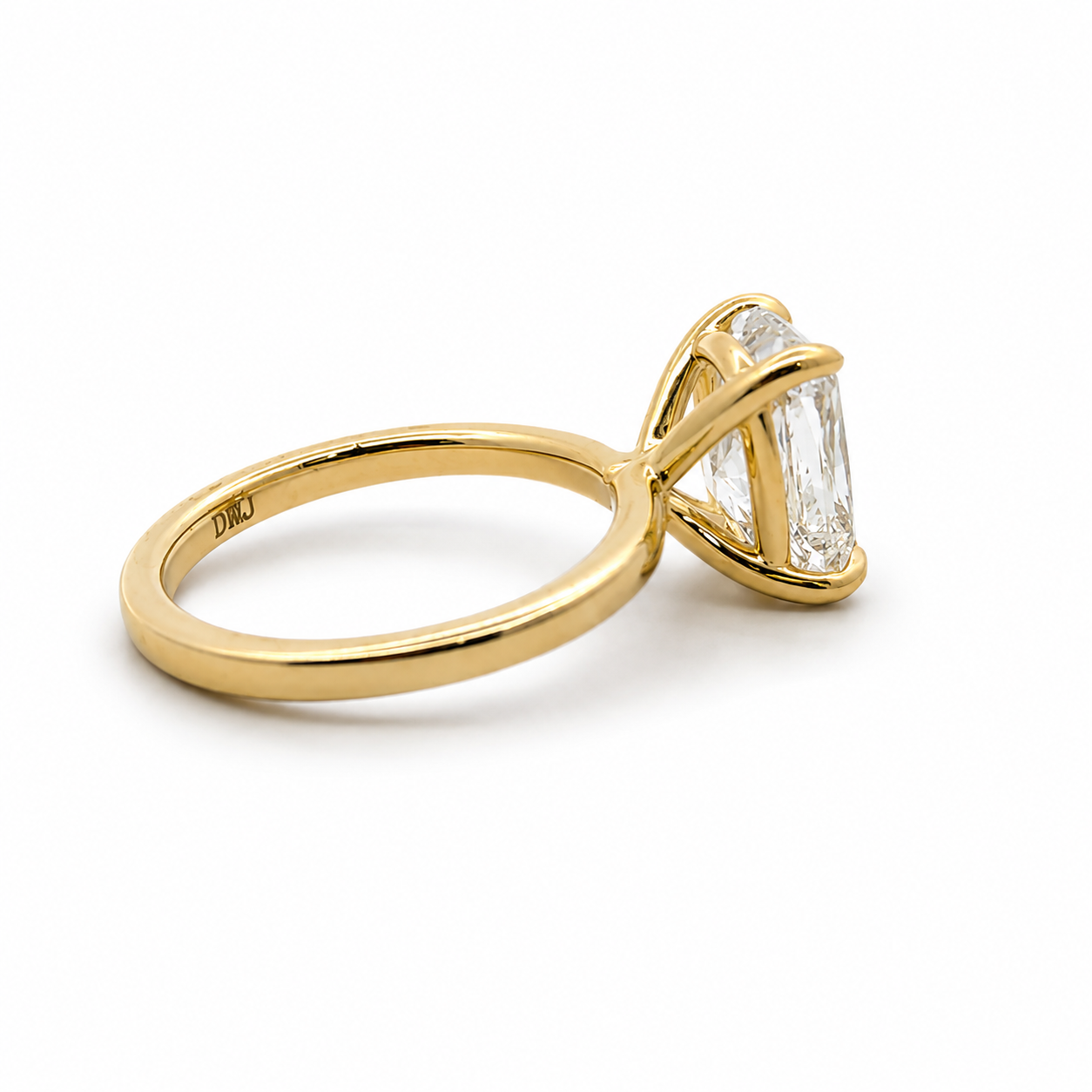 Gold ring with a diamond on a white background