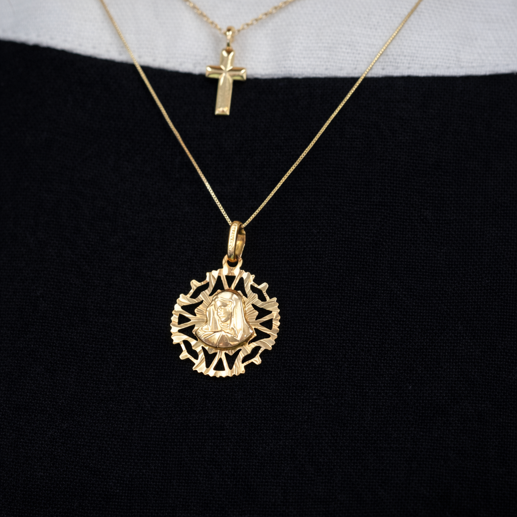 Gold necklace with a round pendant on a black background