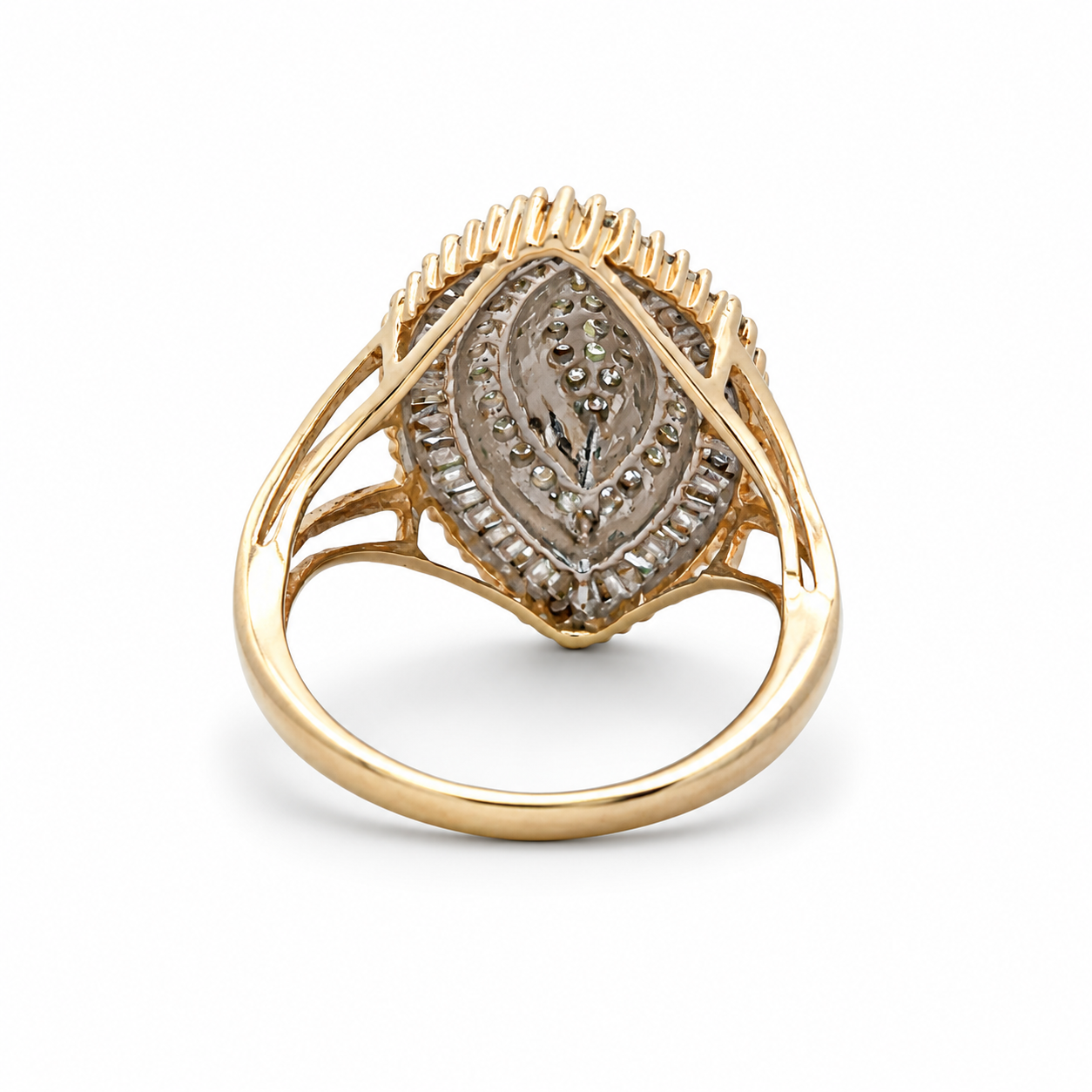 Gold ring with intricate design on a white background