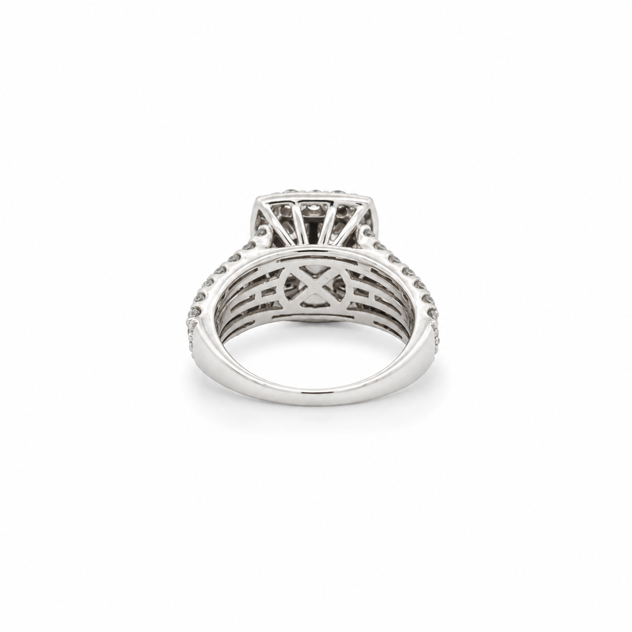 Silver ring with intricate design on a white background