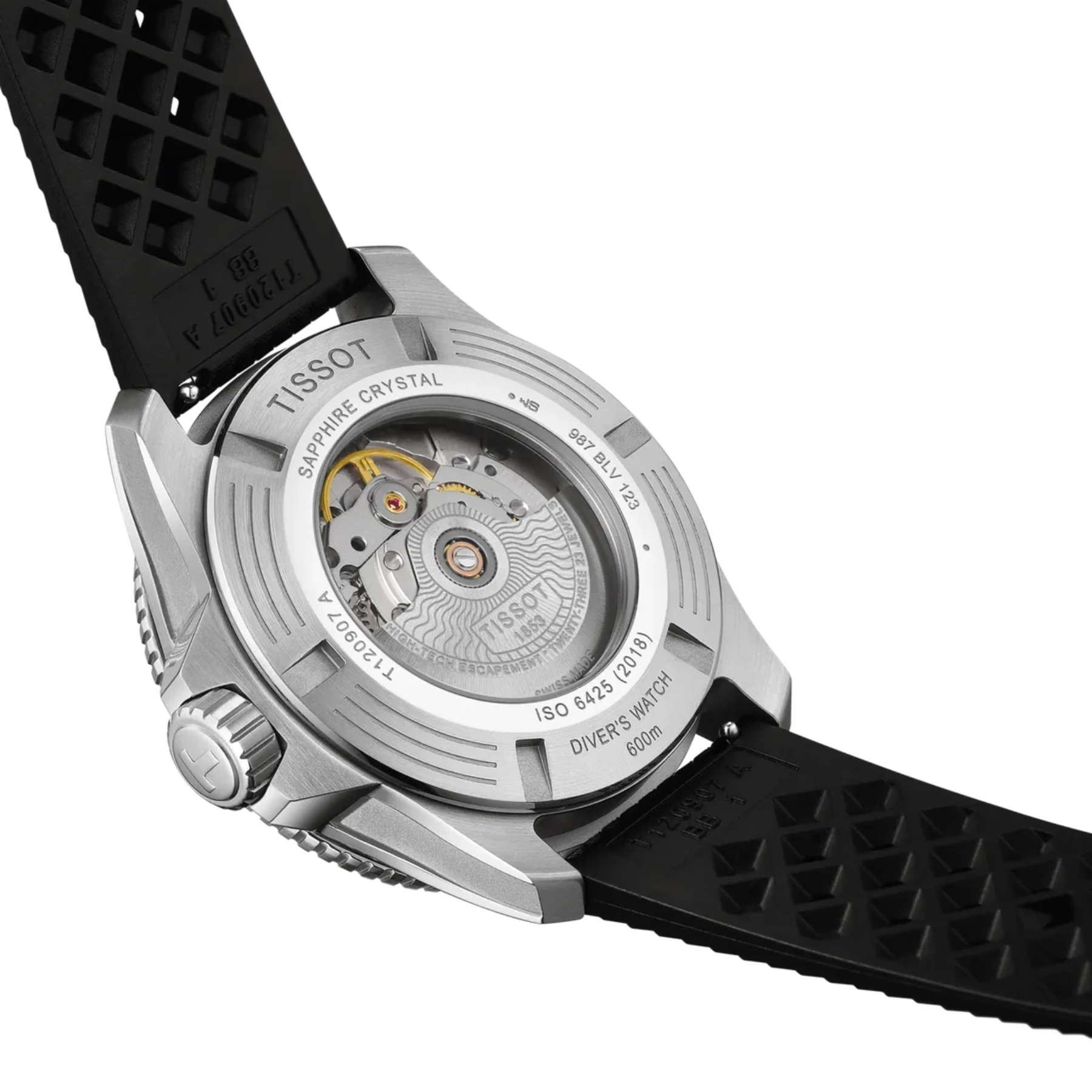Close-up of the back of a Tissot watch with a silver stainless steel case and a black textured rubber strap, showing the automatic movement through the crystal.