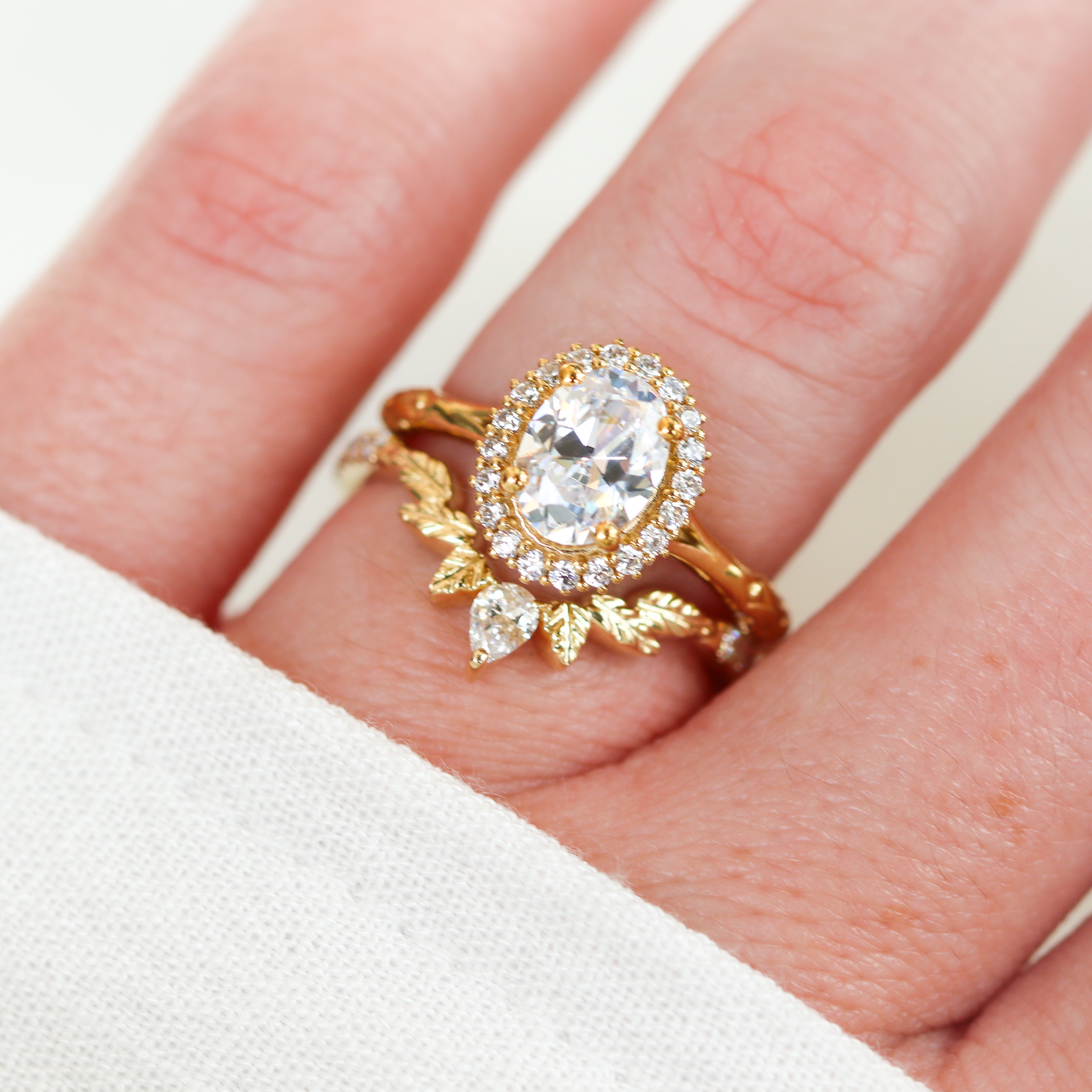 14K Yellow Gold 0.25CTW. Lab-Grown Diamond Leaf-Style Tiara Band with an engagement ring on a finger.